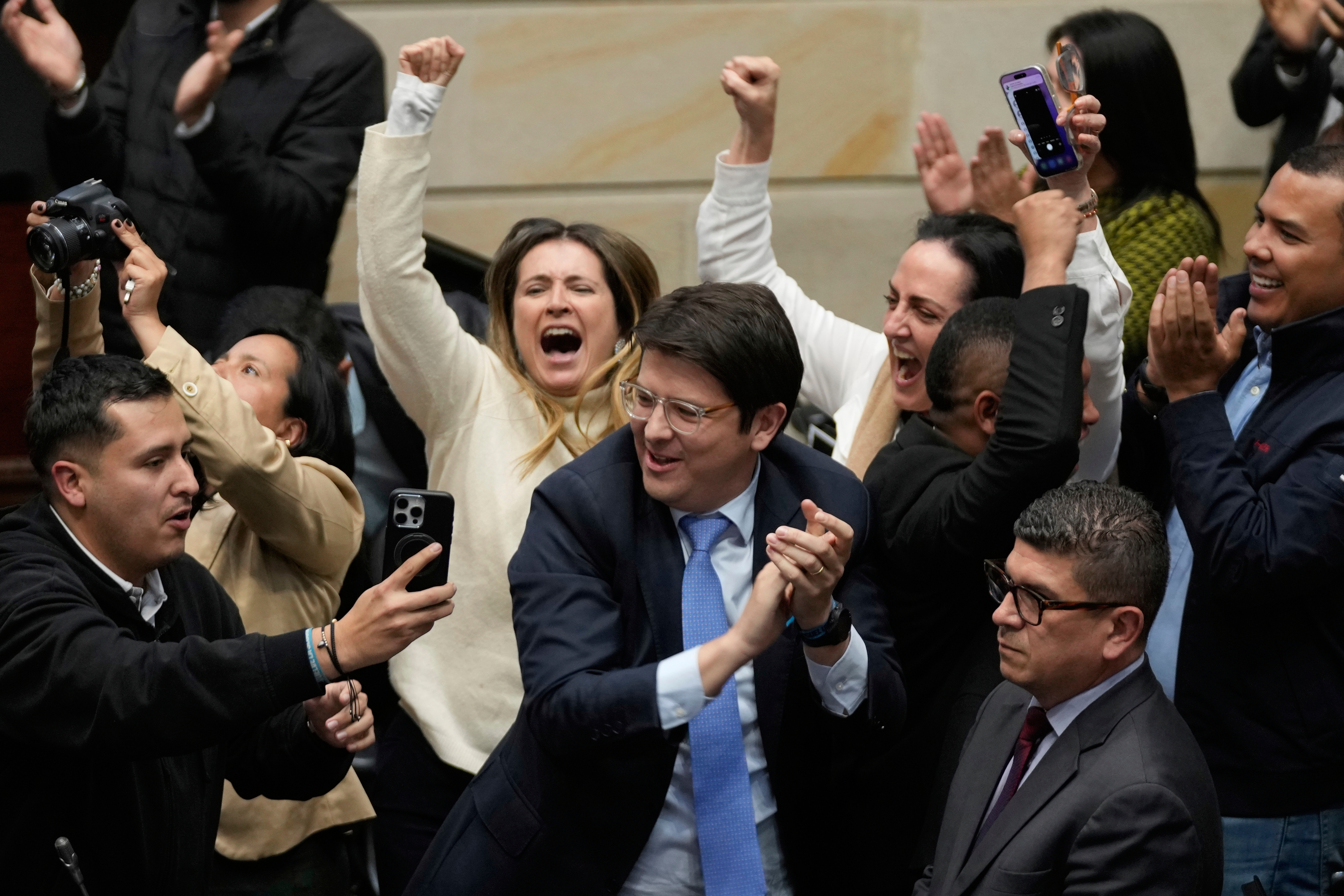 Miguel Uribe Turbay, center in blue tie, a Colombian senator and presidential candidate for the right-wing Centro Democrático party, celebrates after voting against a labor reform referendum proposed by the government, in Bogota, Colombia, May 14, 2025. 