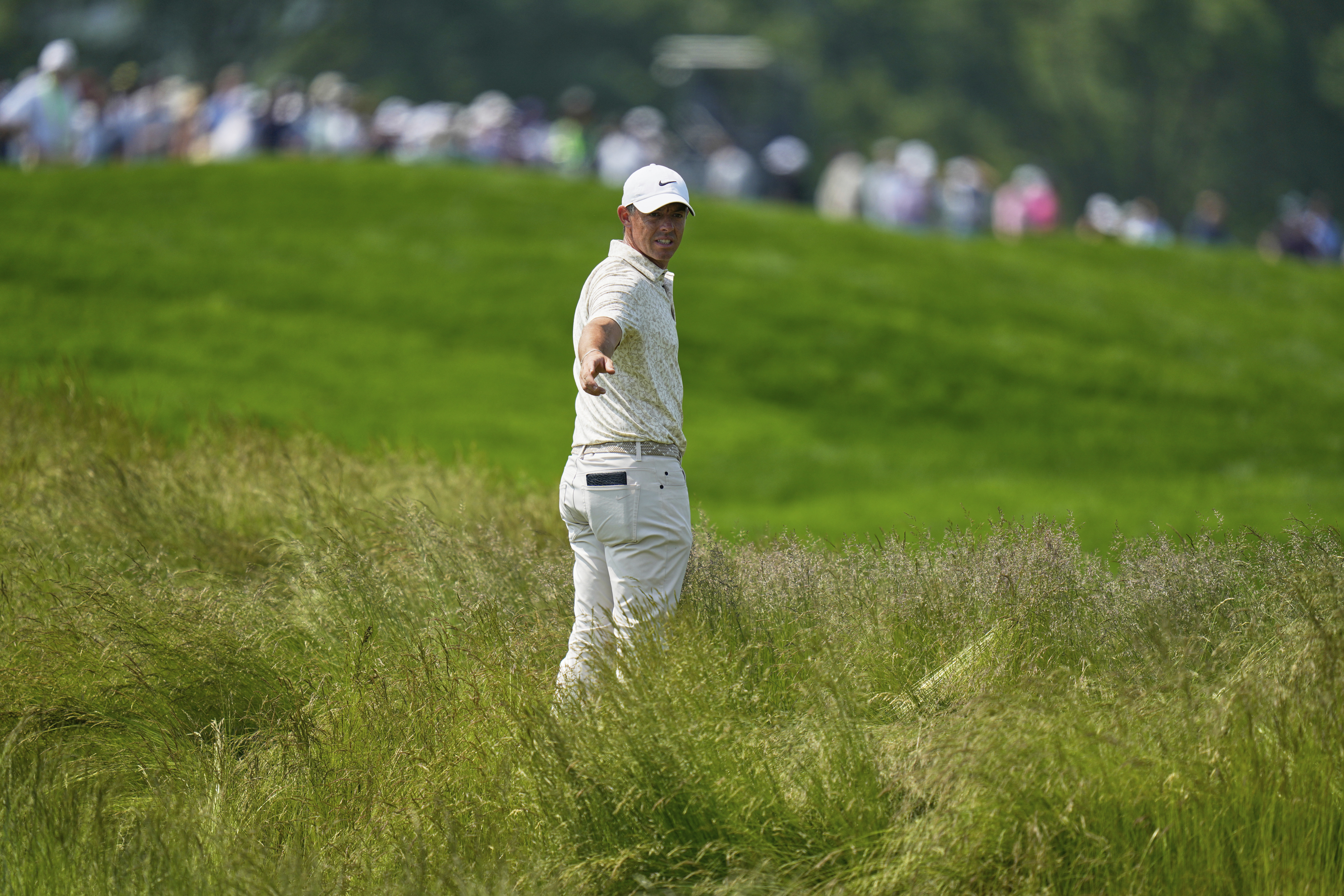 Rory McIlroy, of Northern Ireland, prepares to hit from the tall grass on the fourth hole during the first round of the U.S. Open