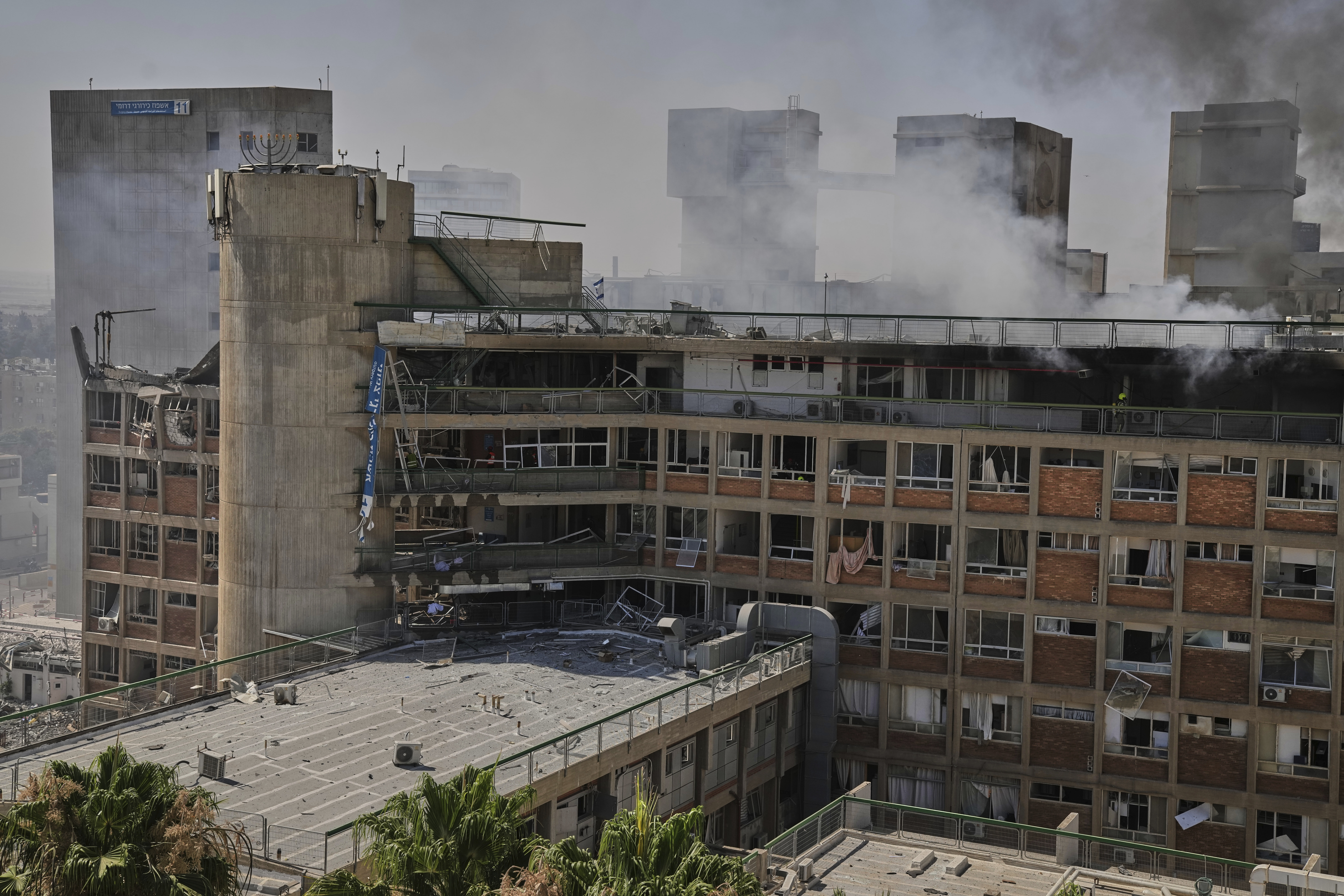 Smokes raises from a building of the Soroka hospital complex after it was hit by a missile fired from Iran in Be'er Sheva, Israel, Thursday, June 19, 2025. (AP Photo/Leo Correa)