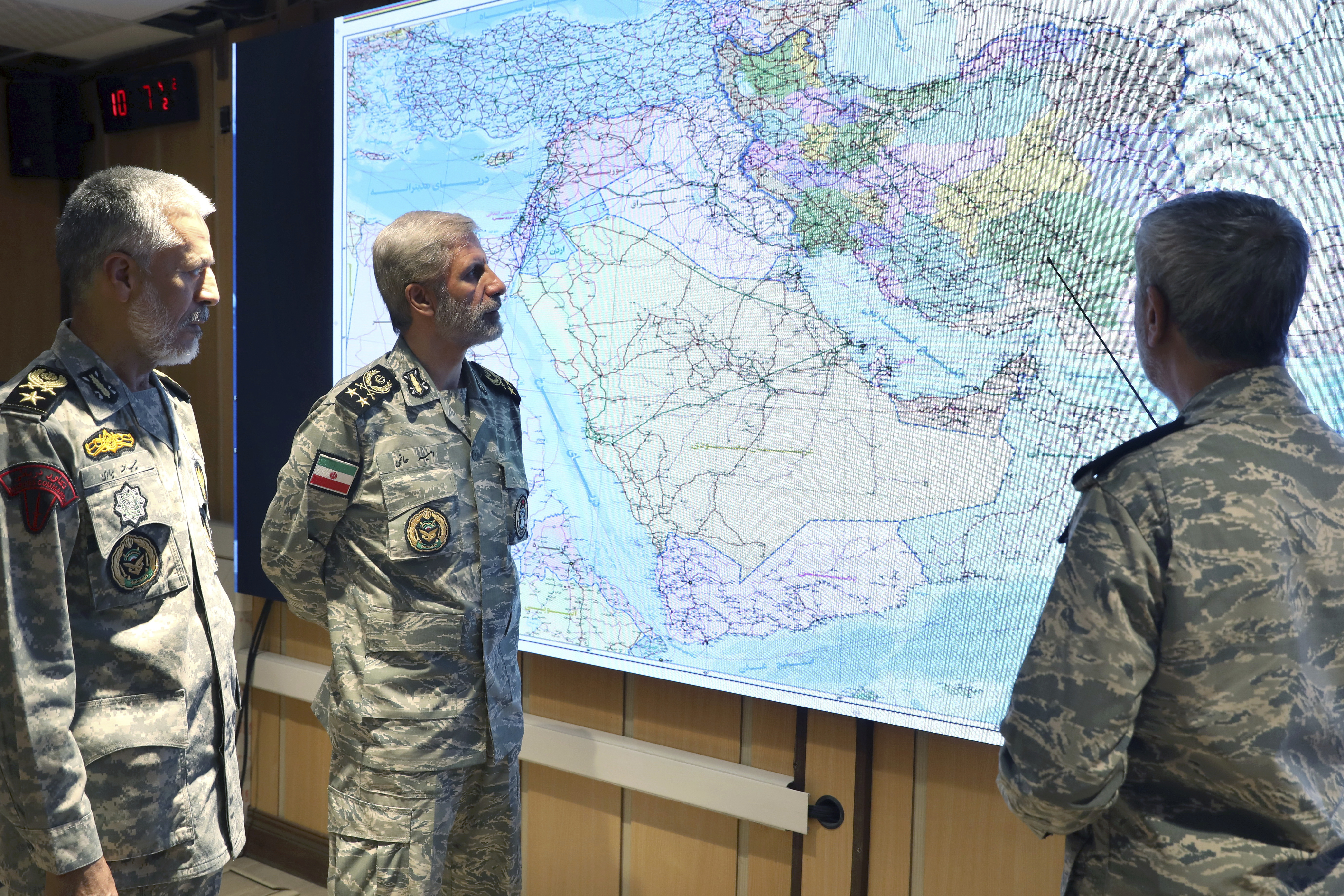 on Monday, 23, 2025, by Iranian army press service, Iran's army commander-in-chief Gen. Amir Hatami, center, Admiral Mahmoud Mousavi, right, and Admiral Habibollah Sayyari attend a meeting in Zolfaghar central headquarters, Iran.