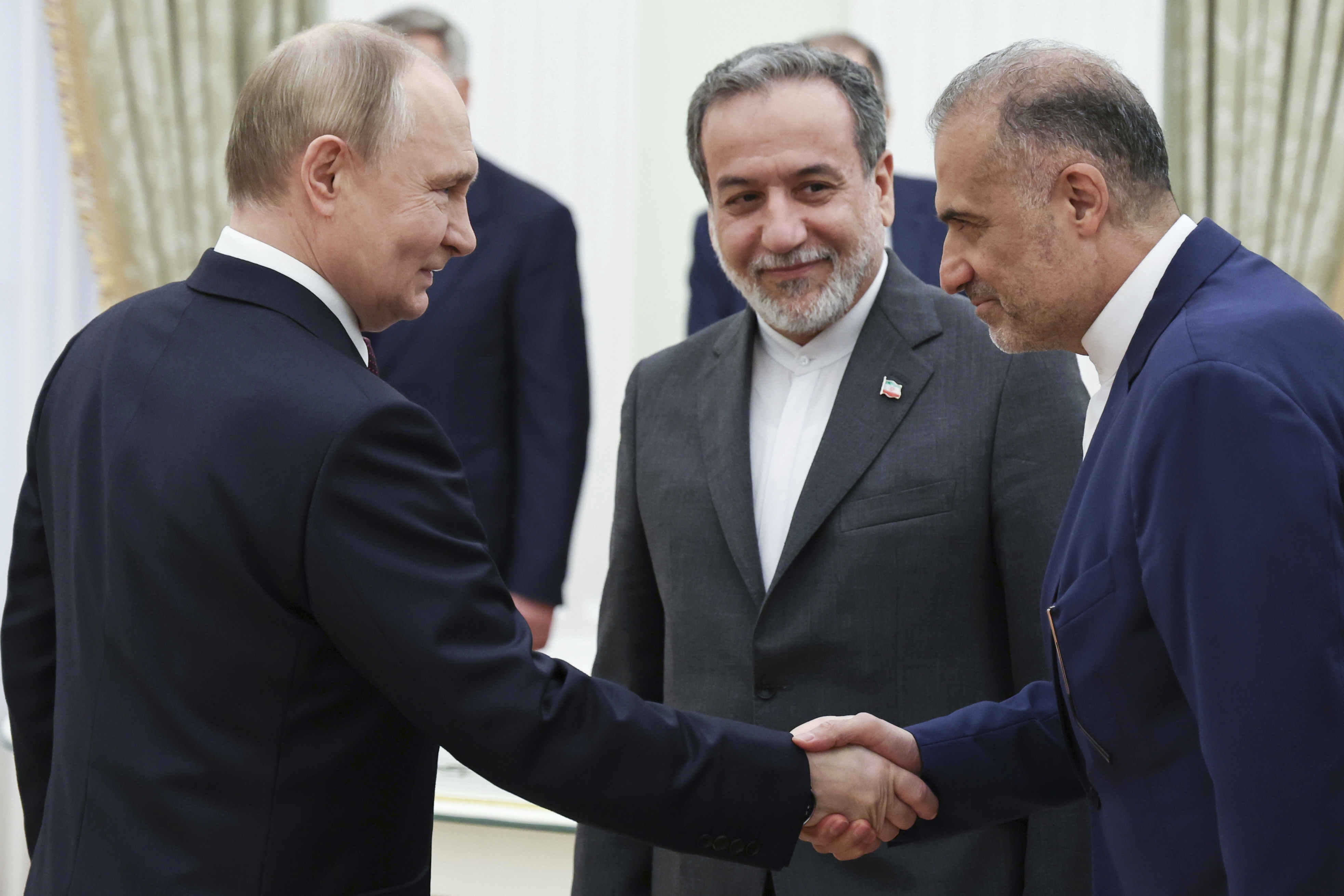 Russian President Vladimir Putin, left, greets Ambassador of Iran to Russia Kazem Jalali, right, and Iranian Foreign Minister Abbas Araghchi, center, prior to their talks at the Kremlin in Moscow, Russia, Monday, June 23, 2025.