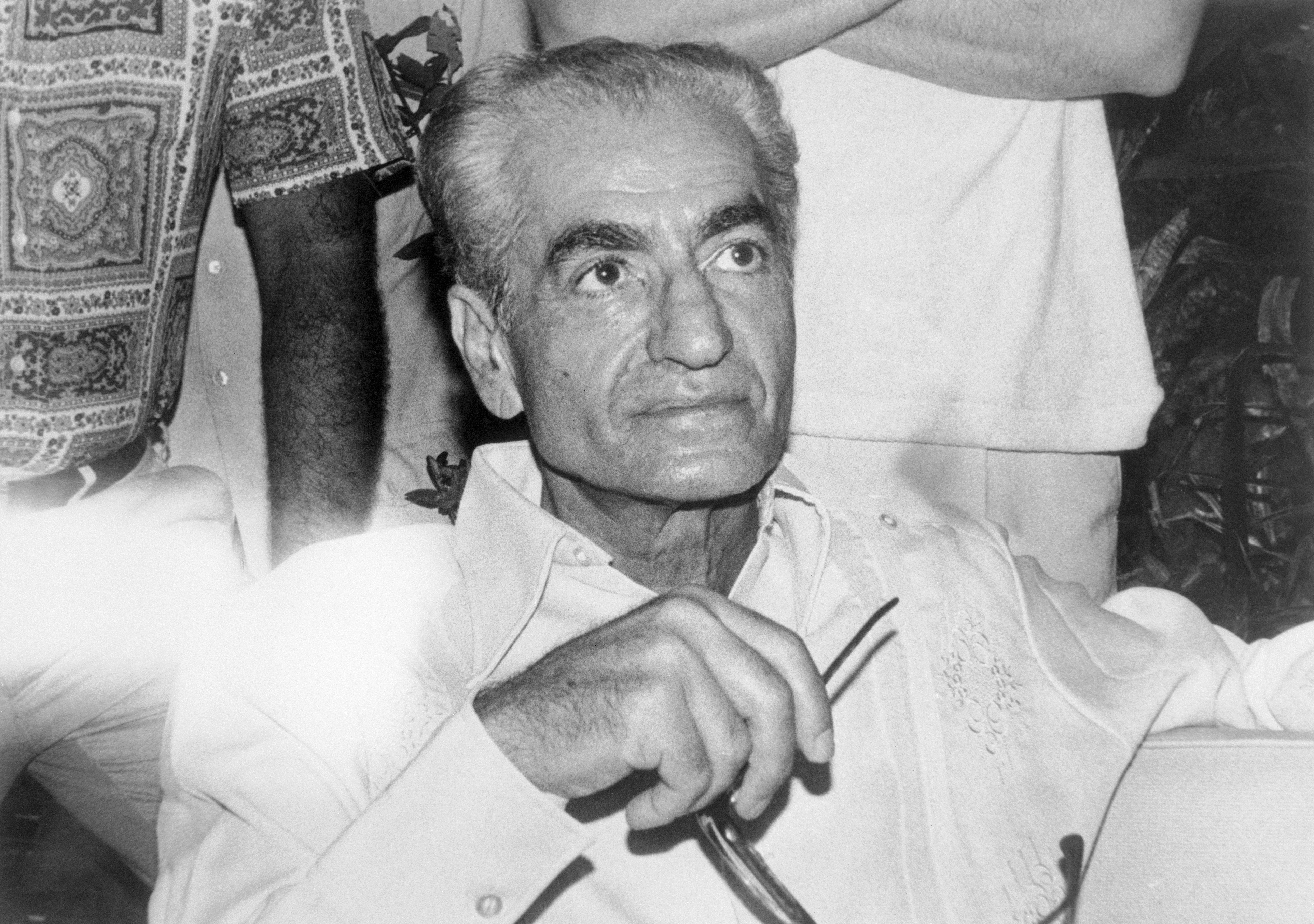 (Original Caption) The former Shah of Iran, Mohammed Reza Pahlevi, during his press conference this afternoon in the house of the former Panamanian ambassador in Washington Gabriel Lewis. The Shah will live here with his wife and some assistants, including one female doctor, four assistants, one private secretary and his assistant, both from the US. The group also has one doberman dog and one poodle.