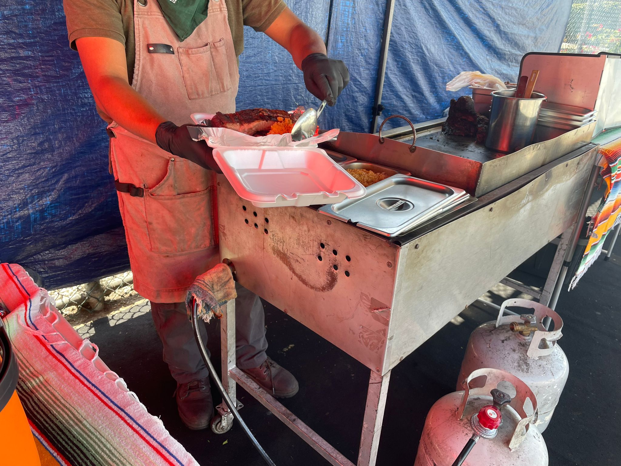 A man places food into a to-go box