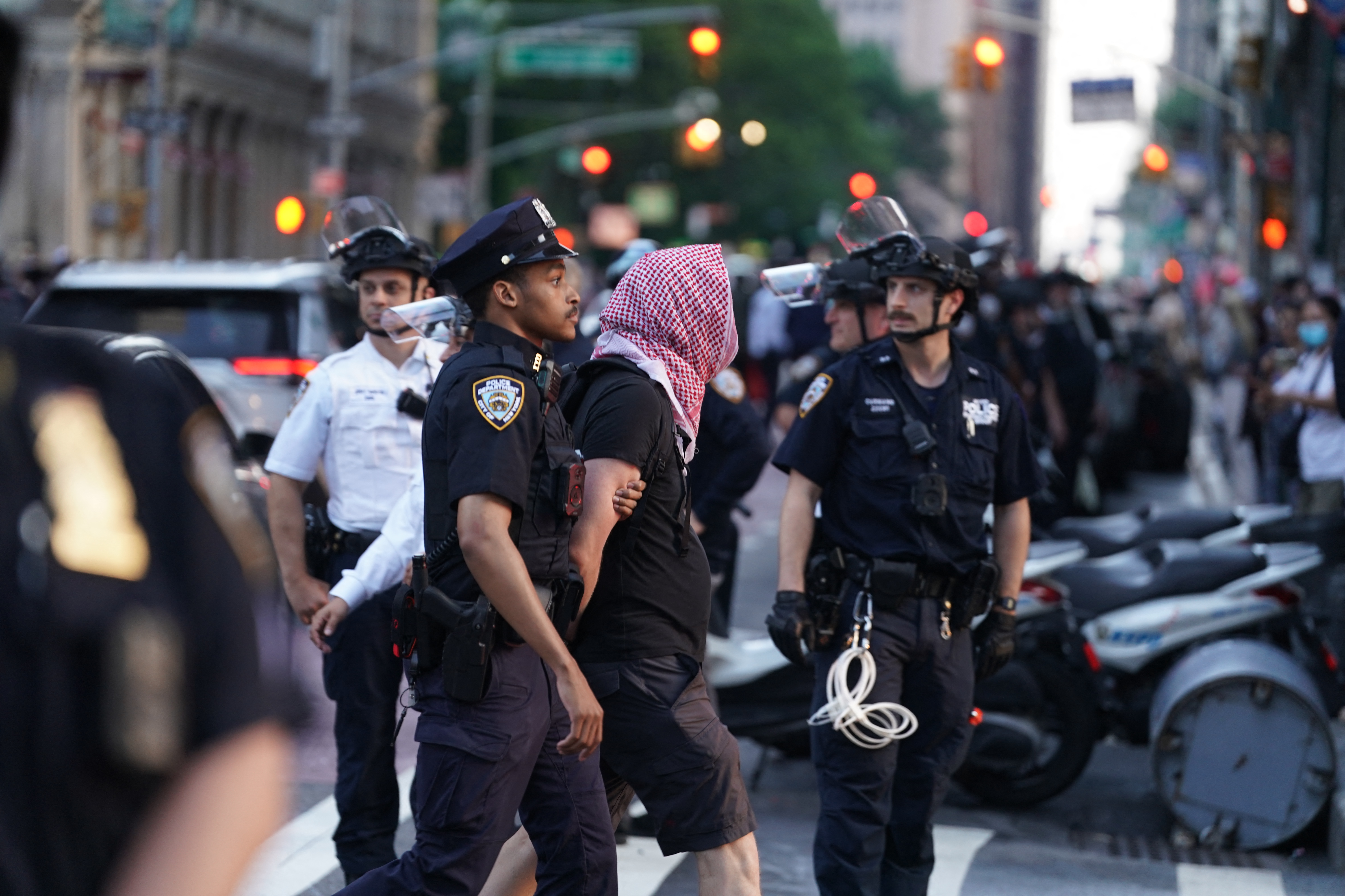 NYPD officers detain a demonstrator during an "ICE Out Of NYC" protest against US Immigration and Customs Enforcement (ICE) and federal immigration operations, in New York City on June 10, 2025.