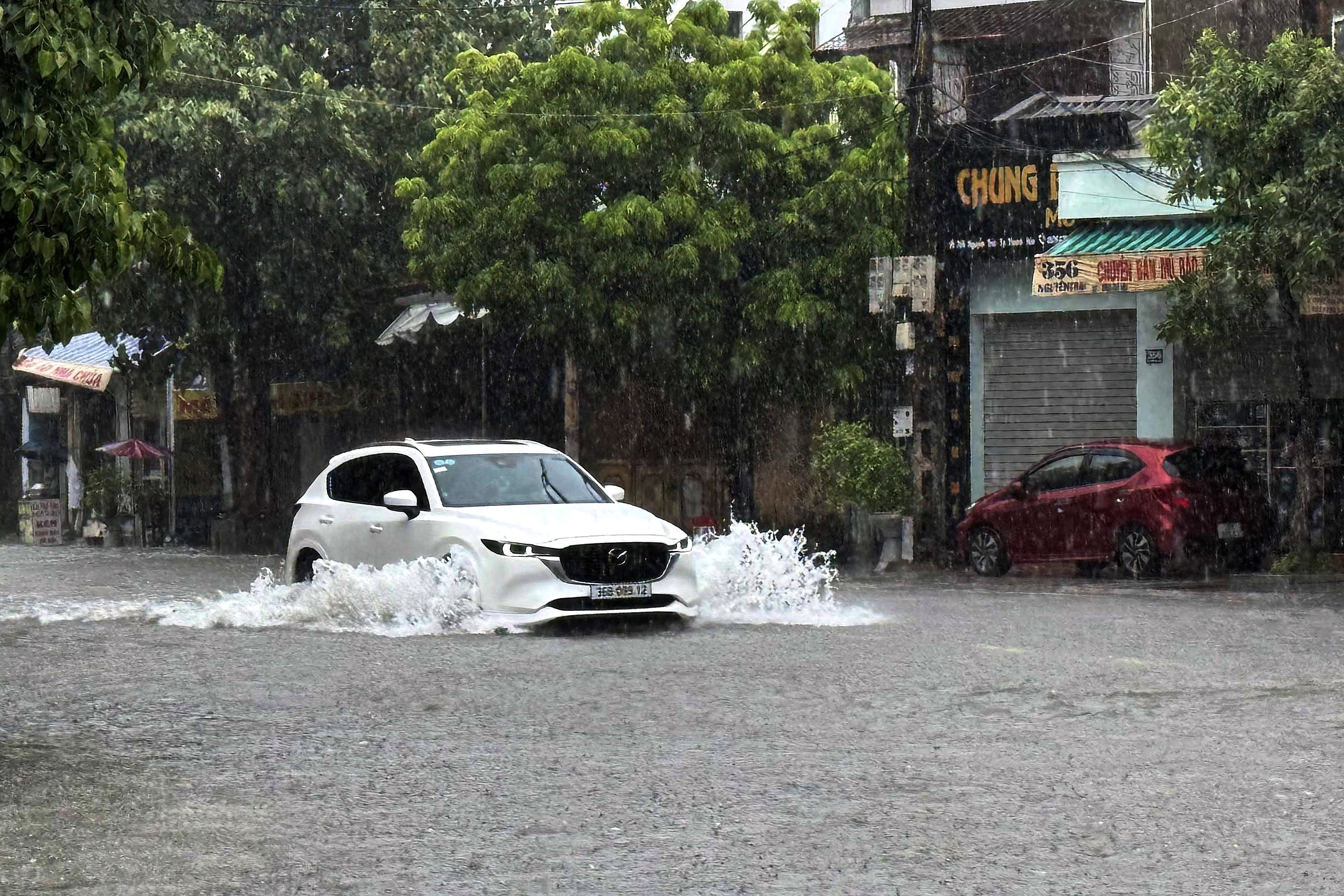 A car drives through a flooded street in Thanh Hoa, about 150 kilometers south of Hanoi, Vietnam on July 22, 2025.
