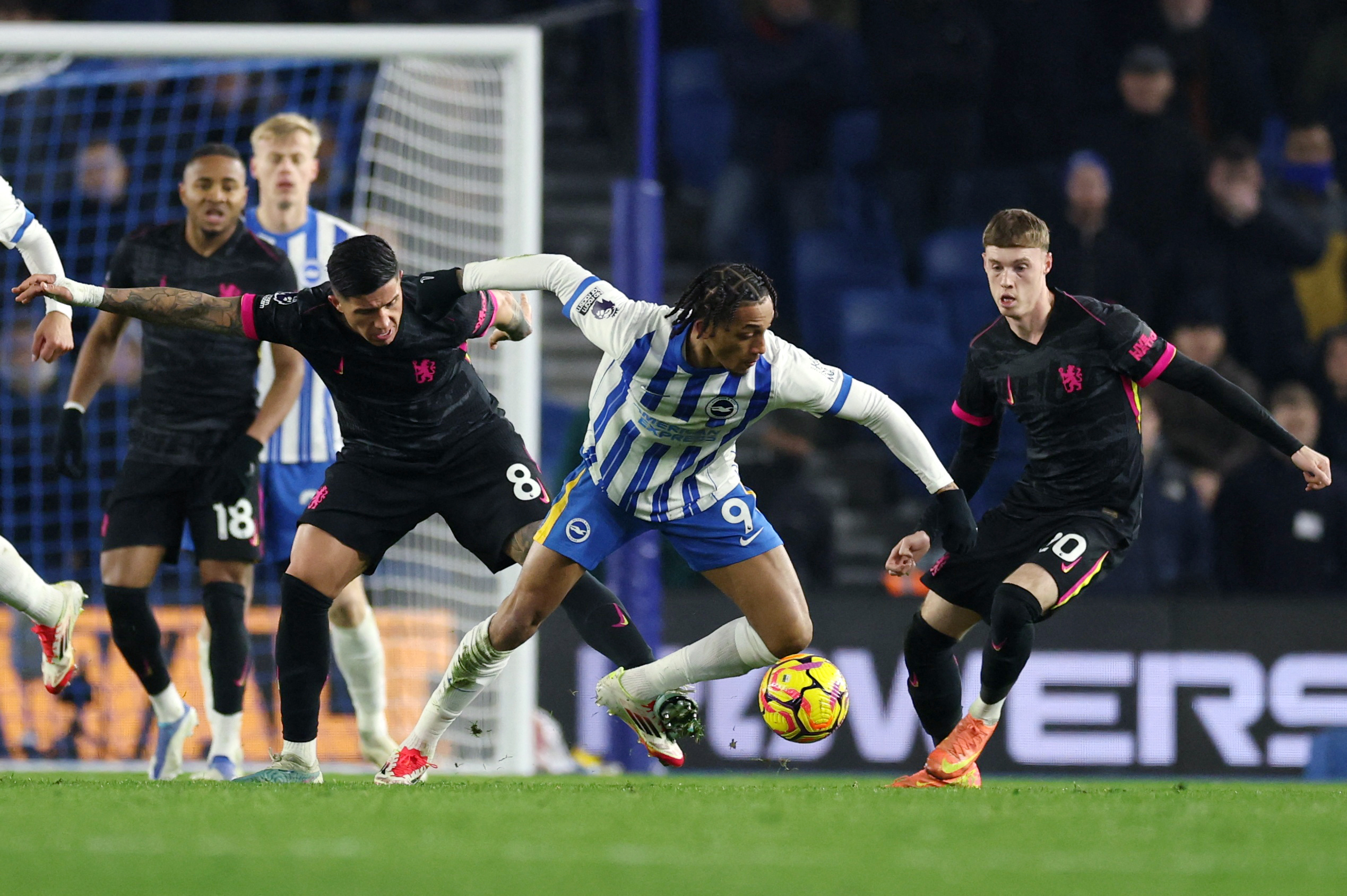 Premier League - Brighton & Hove Albion v Chelsea - The American Express Community Stadium, Brighton, Britain - February 14, 2025 Brighton & Hove Albion's Joao Pedro in action with Chelsea's Cole Palmer and Enzo Fernandez 