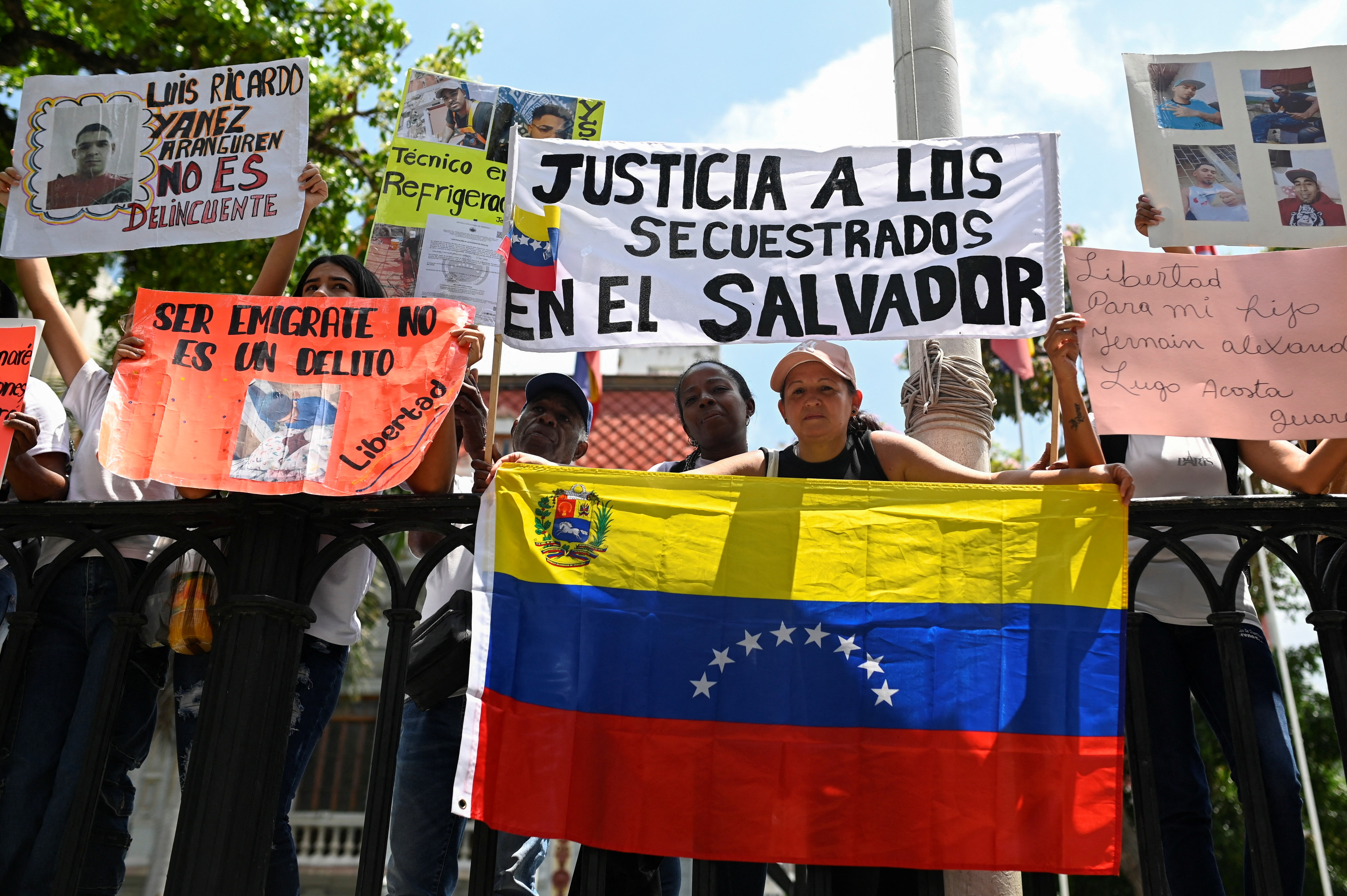 People hold up signs calling for "justice for those imprisoned in El Salvador"