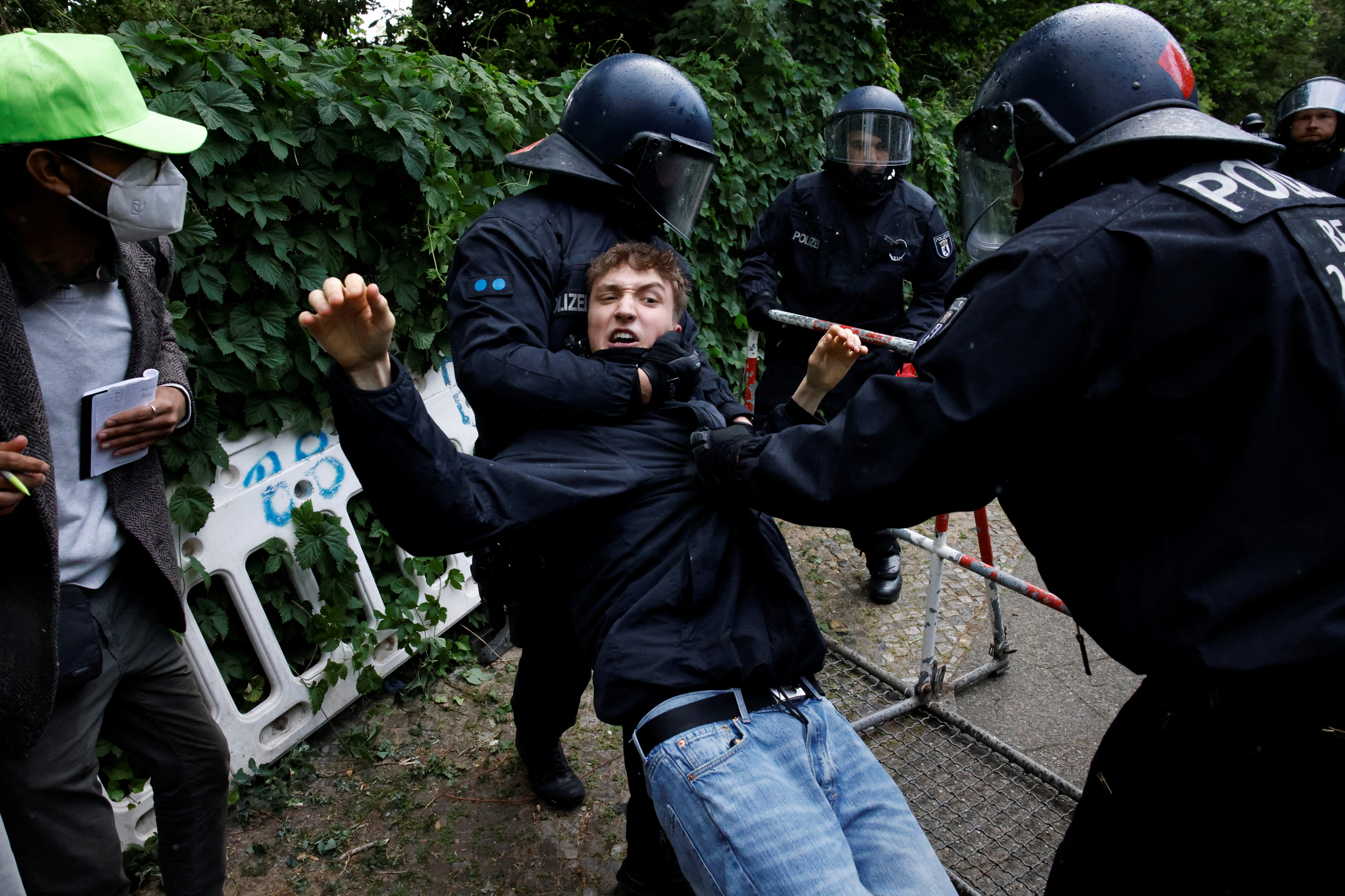 Police officers hold a pro-Palestinian demonstrator during a protest.