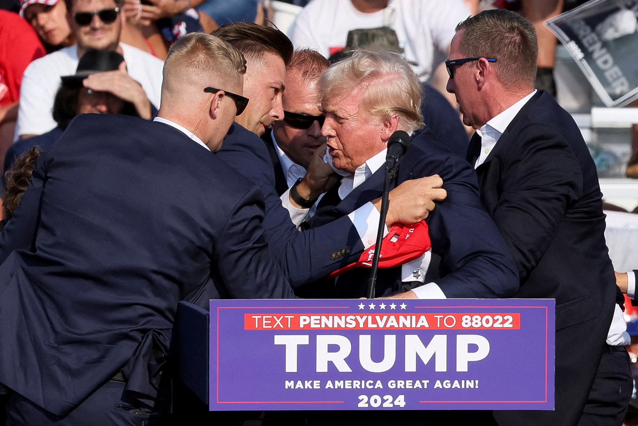 FILE PHOTO: Republican presidential candidate and former U.S. President Donald Trump is assisted by guards during a campaign rally at the Butler Farm Show in Butler, Pennsylvania, U.S., July 13, 2024. REUTERS/Brendan McDermid/File Photo