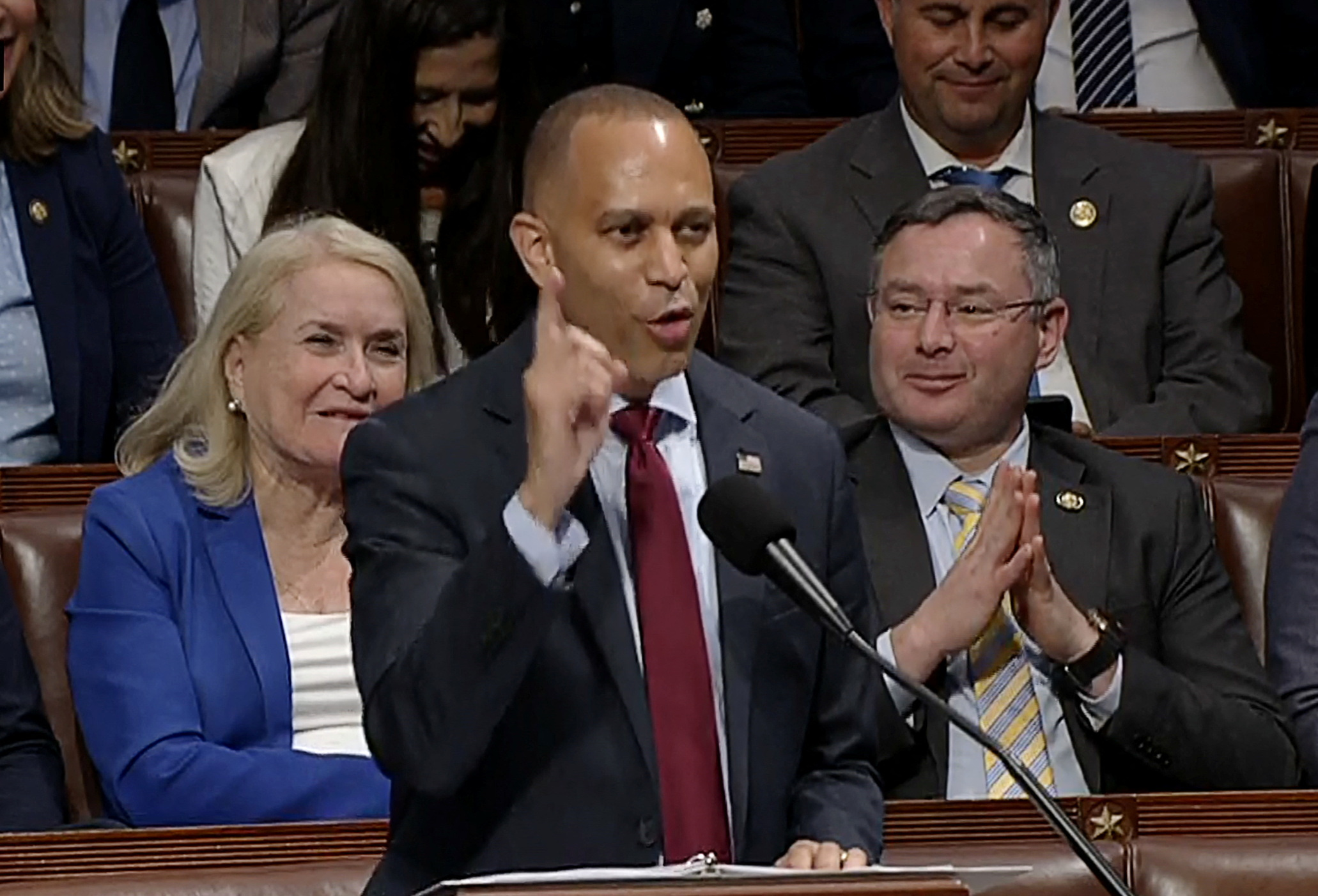 Hakeem Jeffries speaks on the House floor, with Democrats behind him.