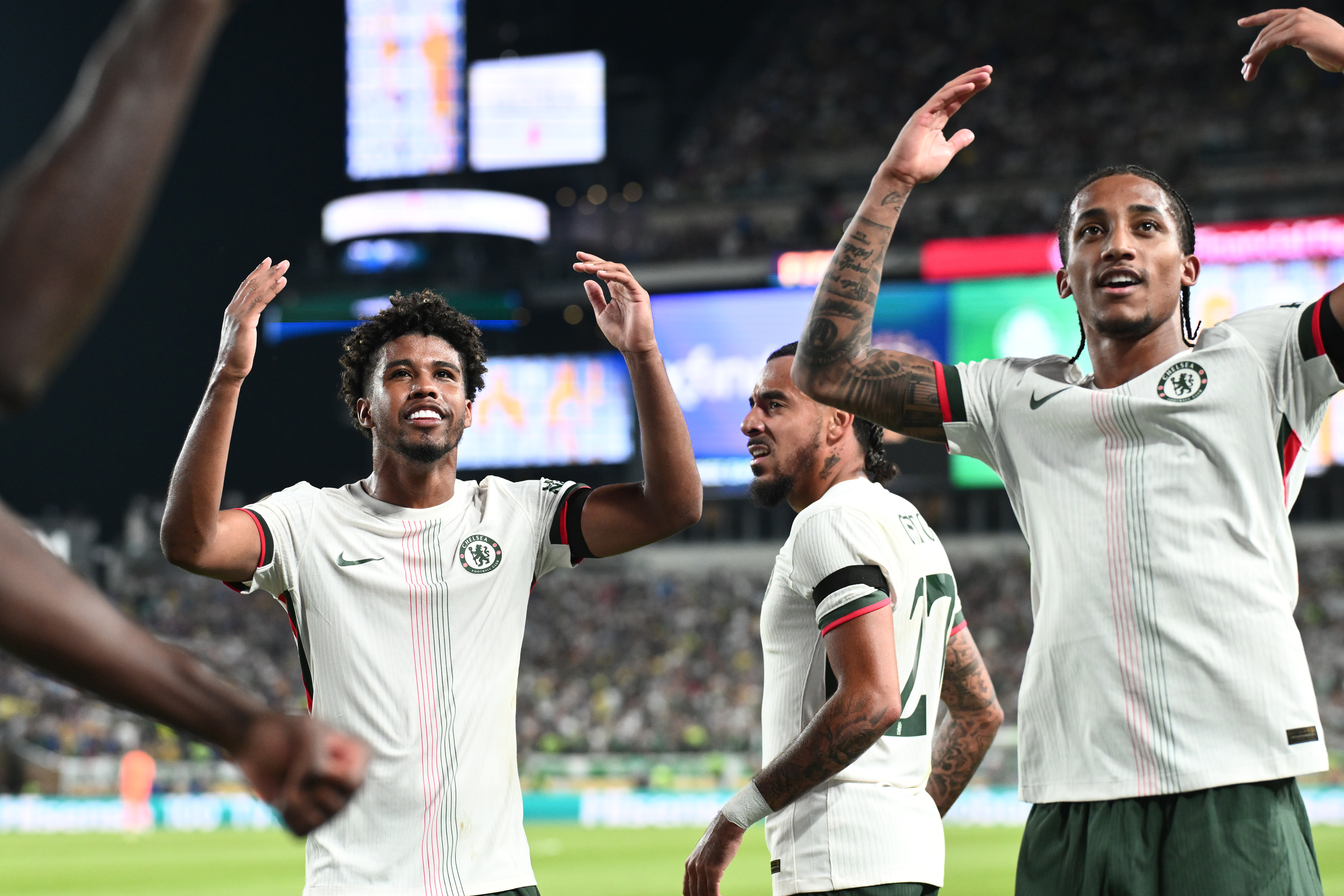 Chelsea FC midfielder Andrey Santos (17) and defender Malo Gusto (27) and forward Joao Pedro (20) celebrate after an own goal by SE Palmeiras in the second half during a quarterfinal
