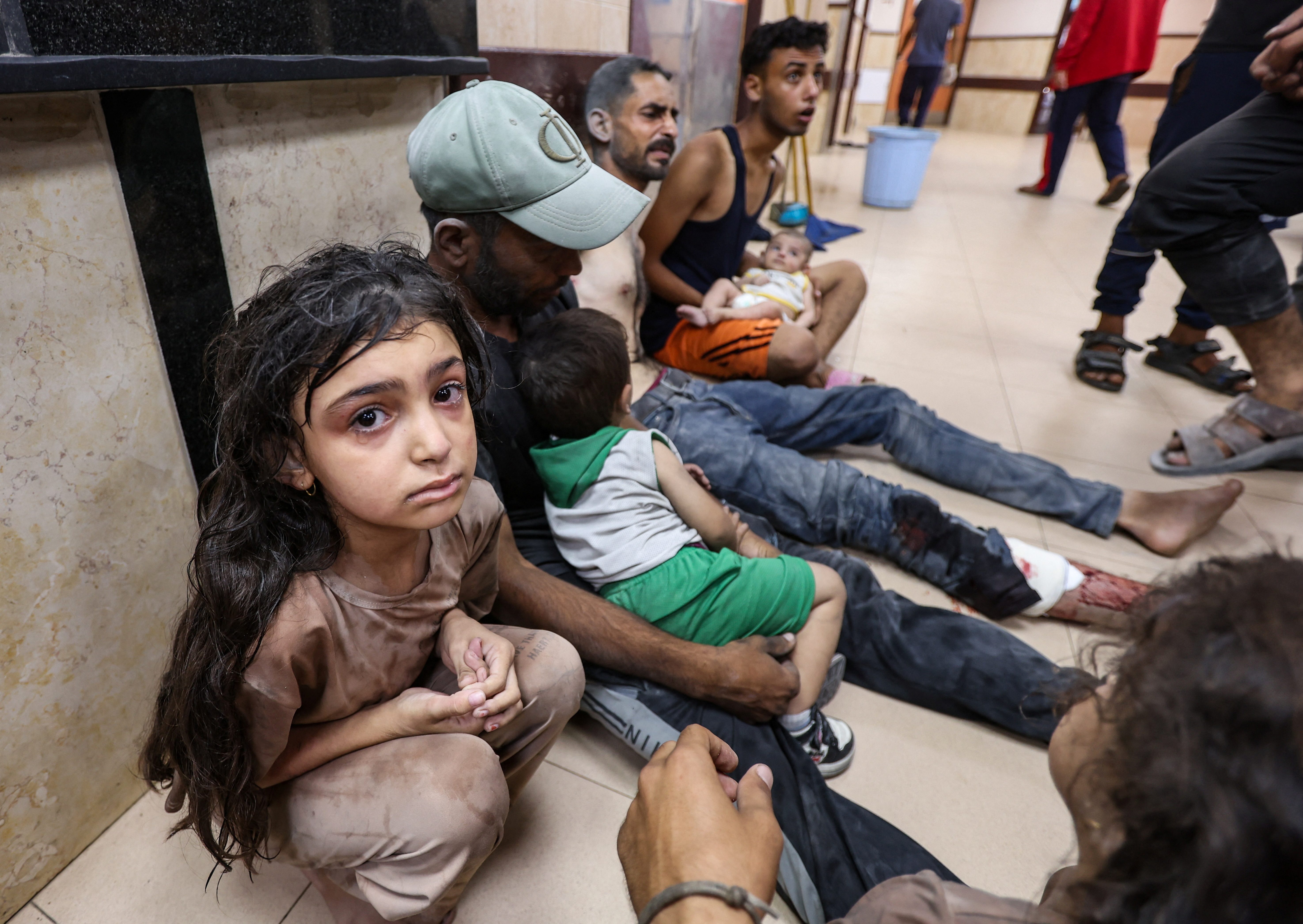 Palestinians, wounded in an Israeli airstrike on a house, receive treatment at Al-Aqsa Martyrs Hospital in Deir al-Balah, central Gaza Strip