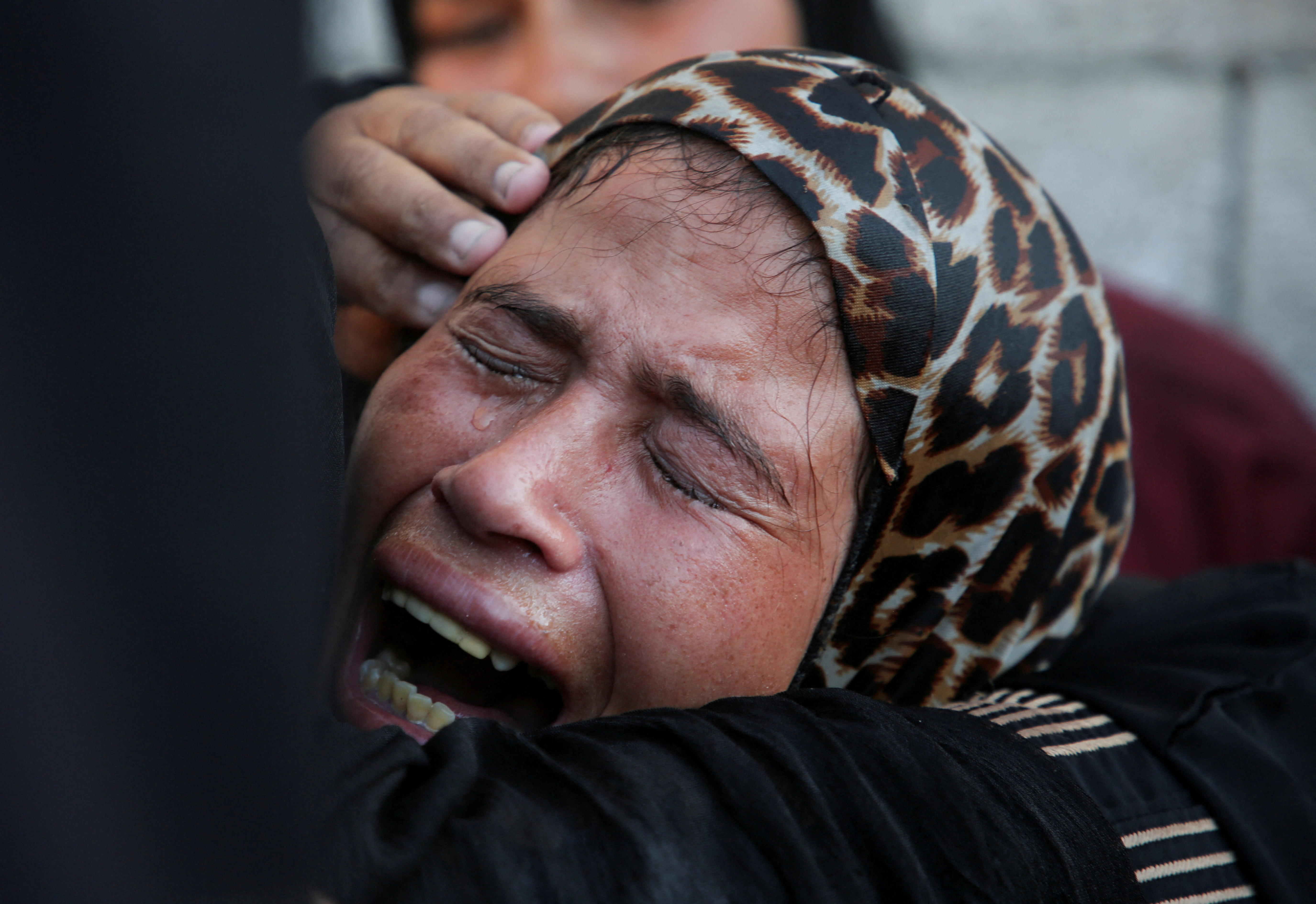 A mourner reacts during the funeral of Palestinians killed overnight in Israeli attacks on tents, according to Gaza's health ministry, at Nasser Hospital in Khan Younis, southern Gaza Strip, July 9, 2025.