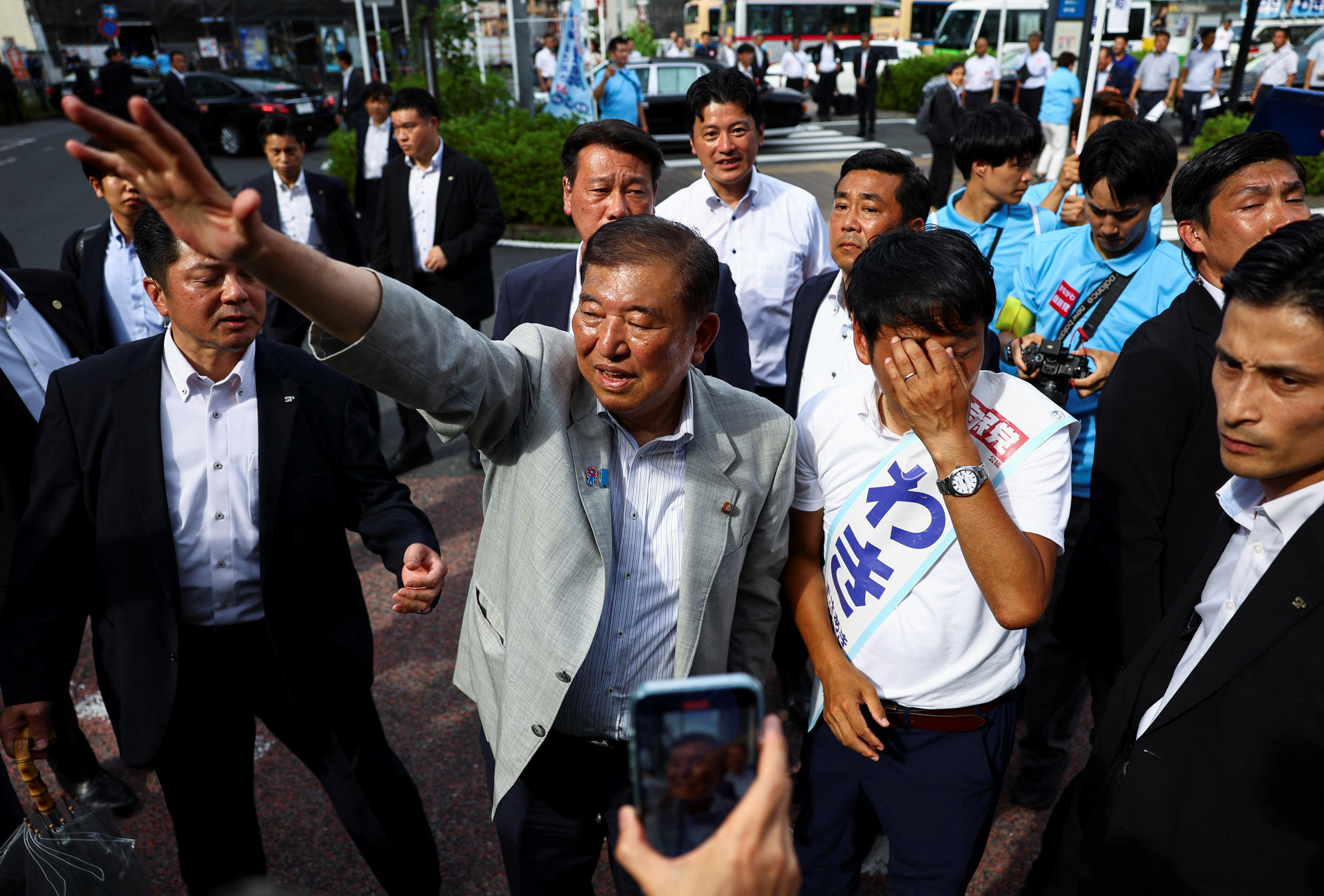 Japan's Prime Minister Shigeru Ishiba waves to voters.