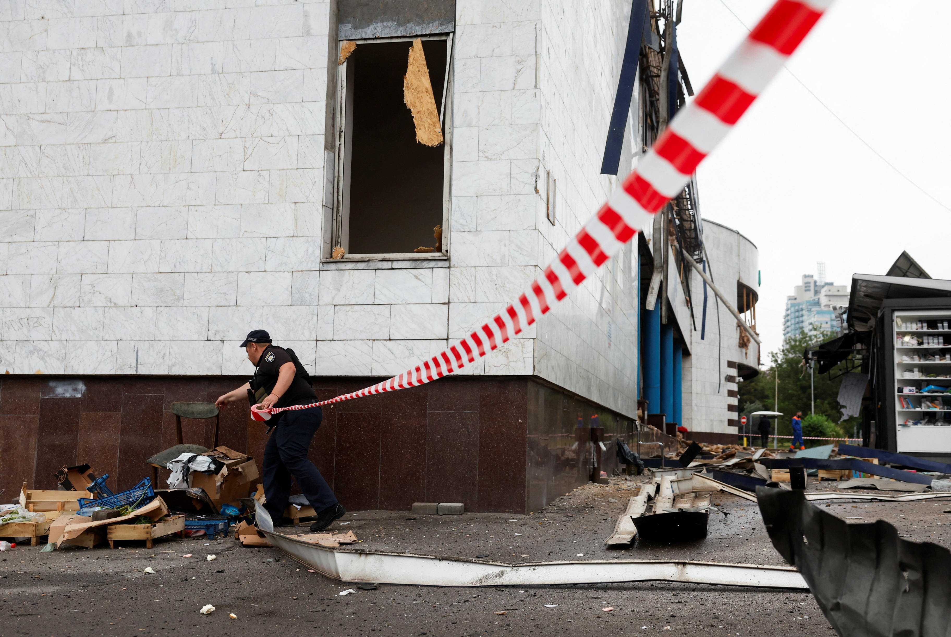 A police officer works at the site of a metro station that was damaged during the night due to Russian drone and missile strikes, amid Russia's attack on Ukraine, in Kyiv, Ukraine July 21, 2025. REUTERS/Thomas Peter