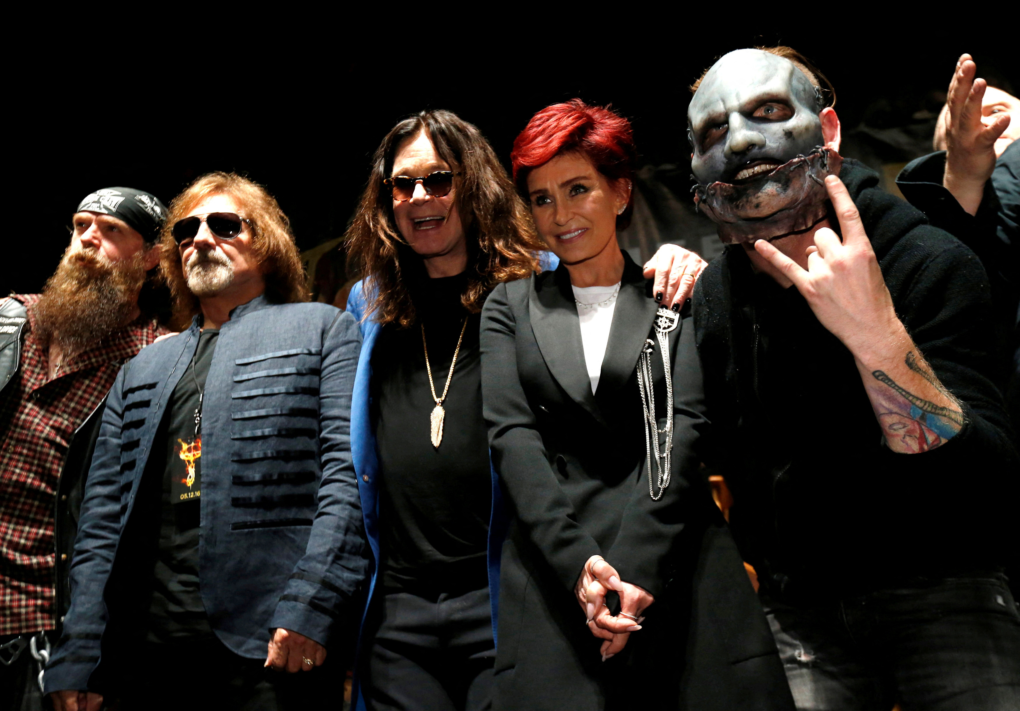 FILE PHOTO: Ozzy Osbourne (C) and his wife Sharon pose with Geezer Butler (2nd L) of Black Sabbath, Zakk Wylde (L) and Slipknot member Corey Taylor (R) at a news conference to announce the "Ozzfest Meets Knotfest" music festival at the Hollywood Palladium in Los Angeles, U.S.,