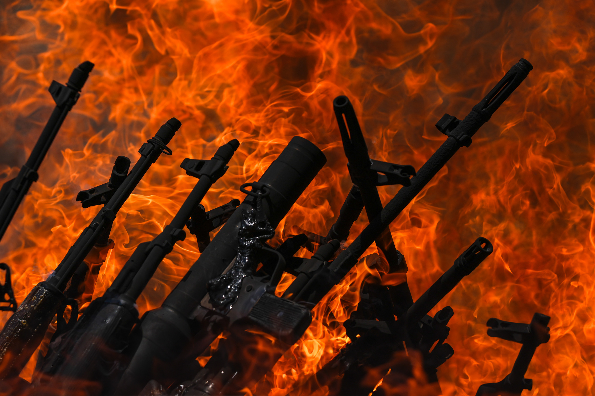 The first group of PKK fighters lays down and destroys their weapons.