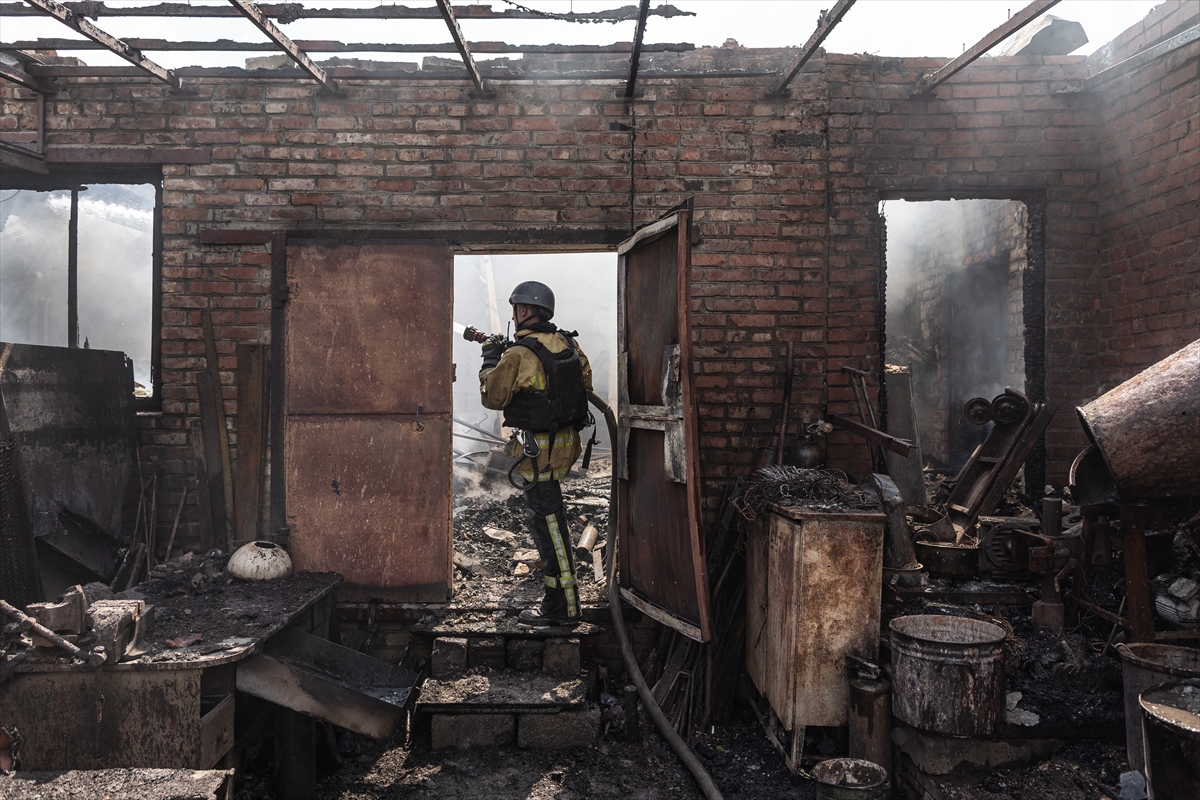 a firefighter stands in a burnout out building