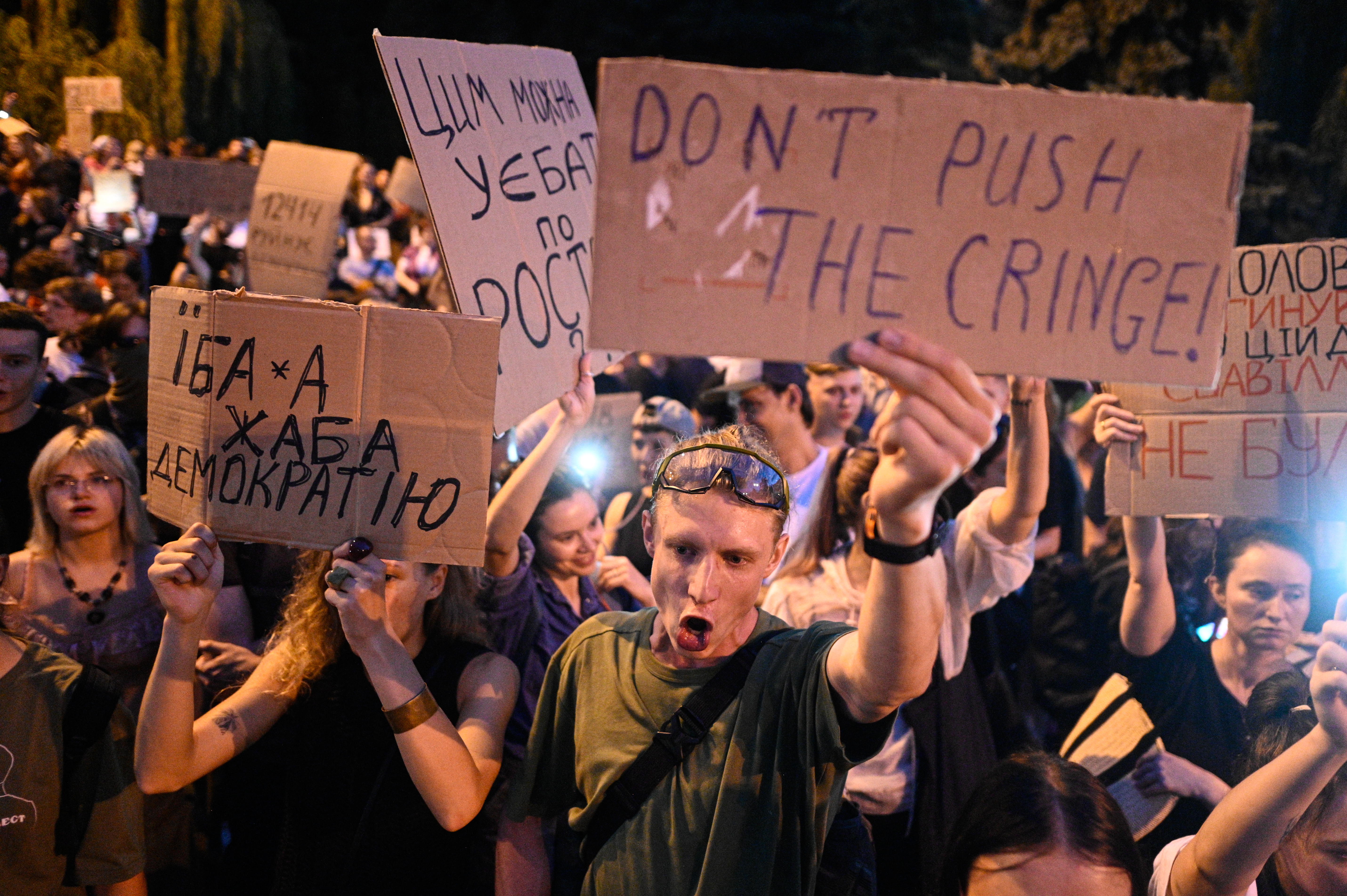 Kyiv residents take part in a rally against the implementation of Zelenskky's bill that undermines the power of anticorruption agencies.