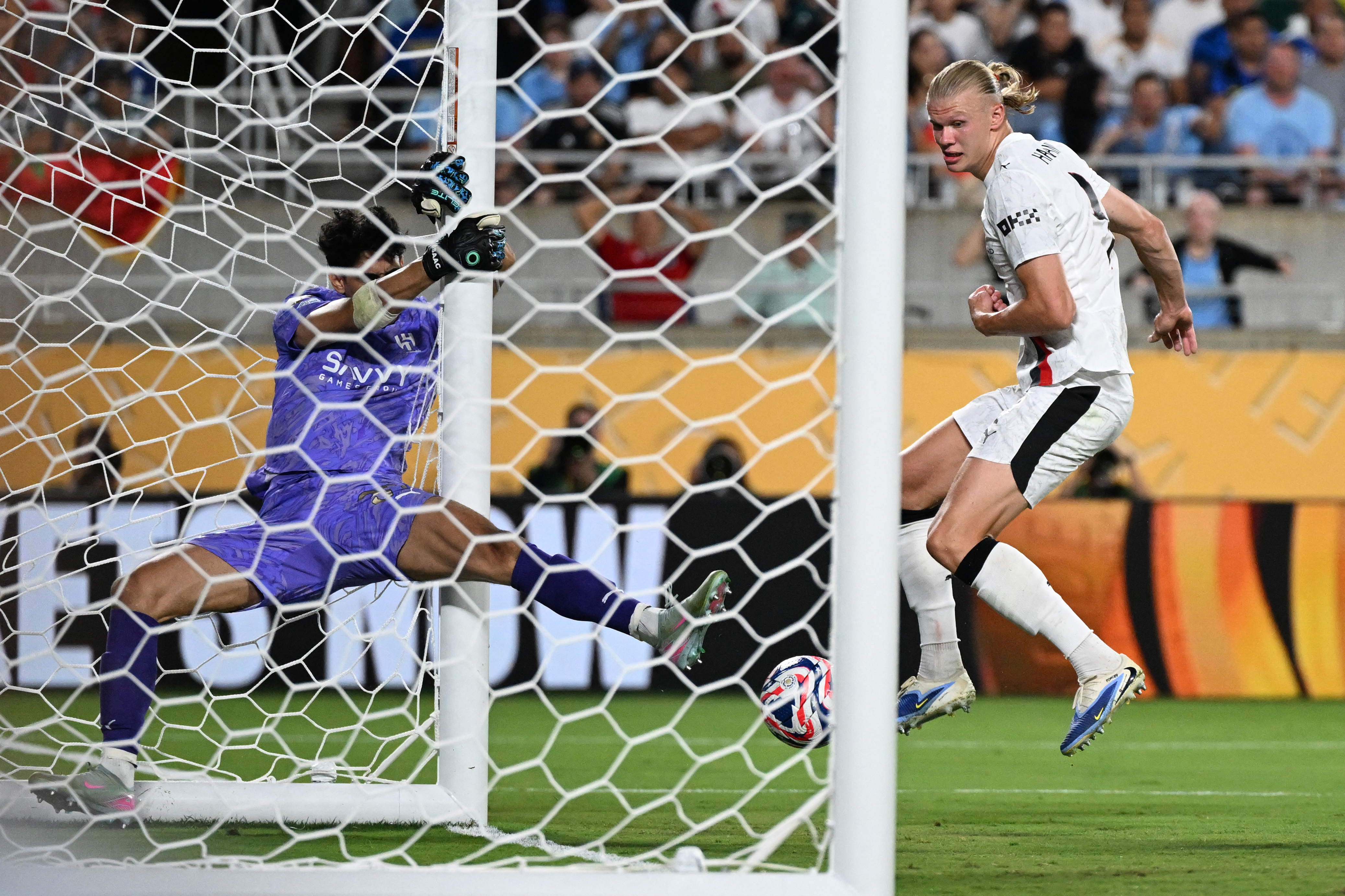 Manchester City's Norwegian striker #09 Erling Haaland shoots but fails to score against Al Hilal's Moroccan goalkeeper #37 Yassine Bounou during the FIFA Club World Cup 2025 round of 16 football match between England's Manchester City and Saudi's Al-Hilal at the Camping World stadium in Orlando on June 30, 2025. (Photo by PATRICIA DE MELO MOREIRA / AFP)