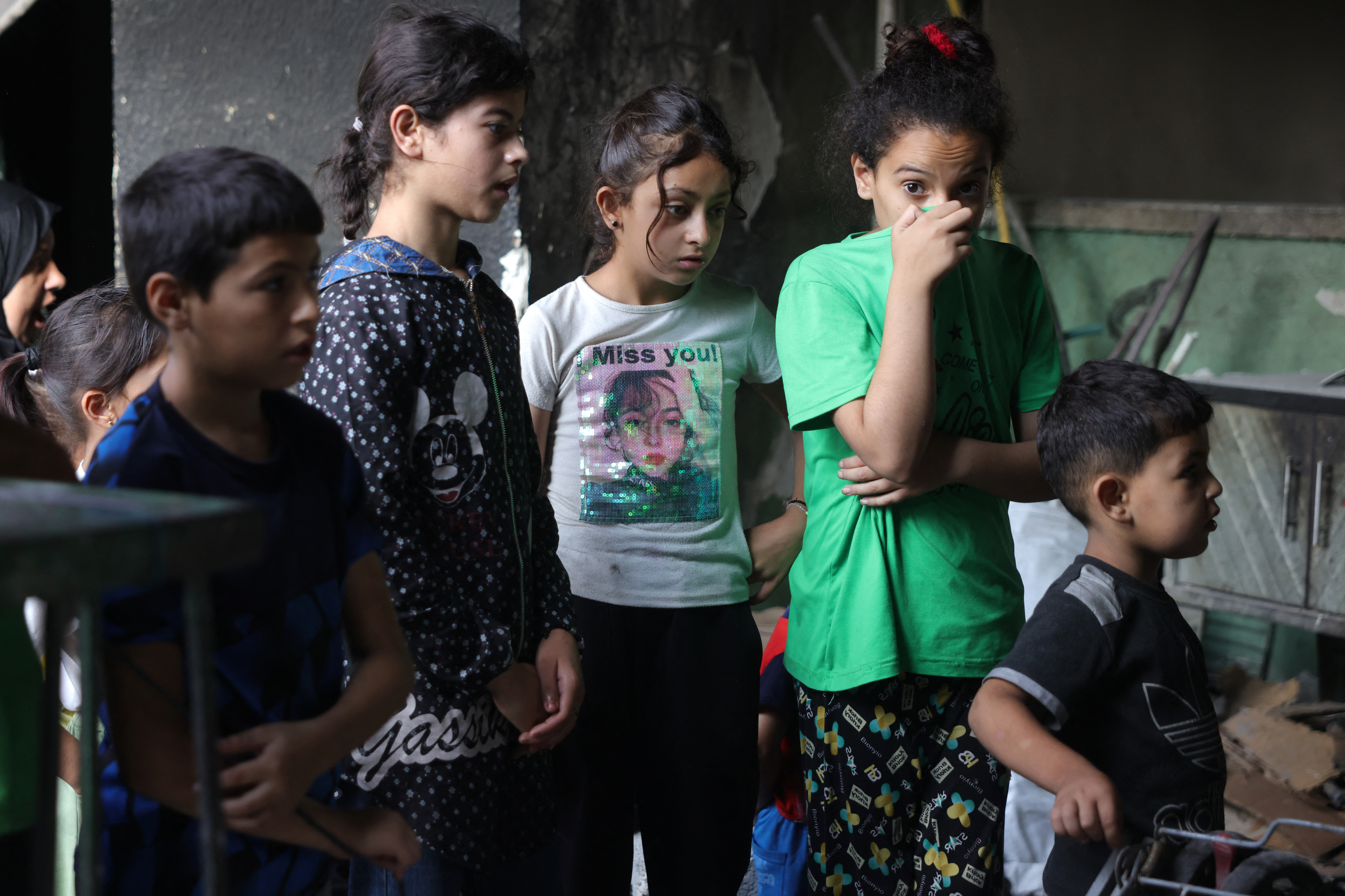 Palestinian children at the site of an Israeli strike on a school.