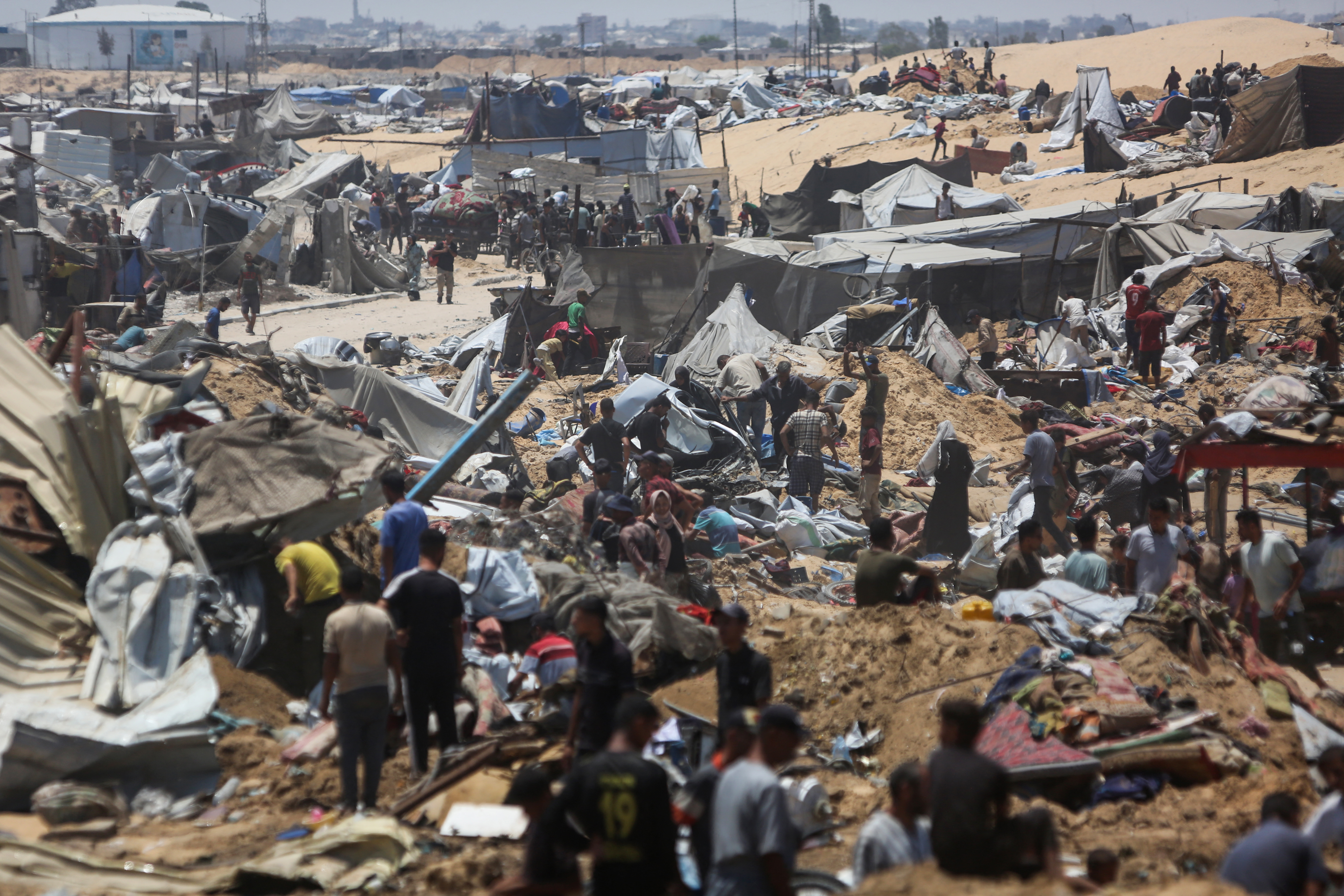Palestinians inspect the destruction at a makeshift displacement camp following a reported incursion a day earlier by Israeli tanks in the area in Khan Yunis in the northern Gaza strip on July 11, 2025. (Photo by AFP)