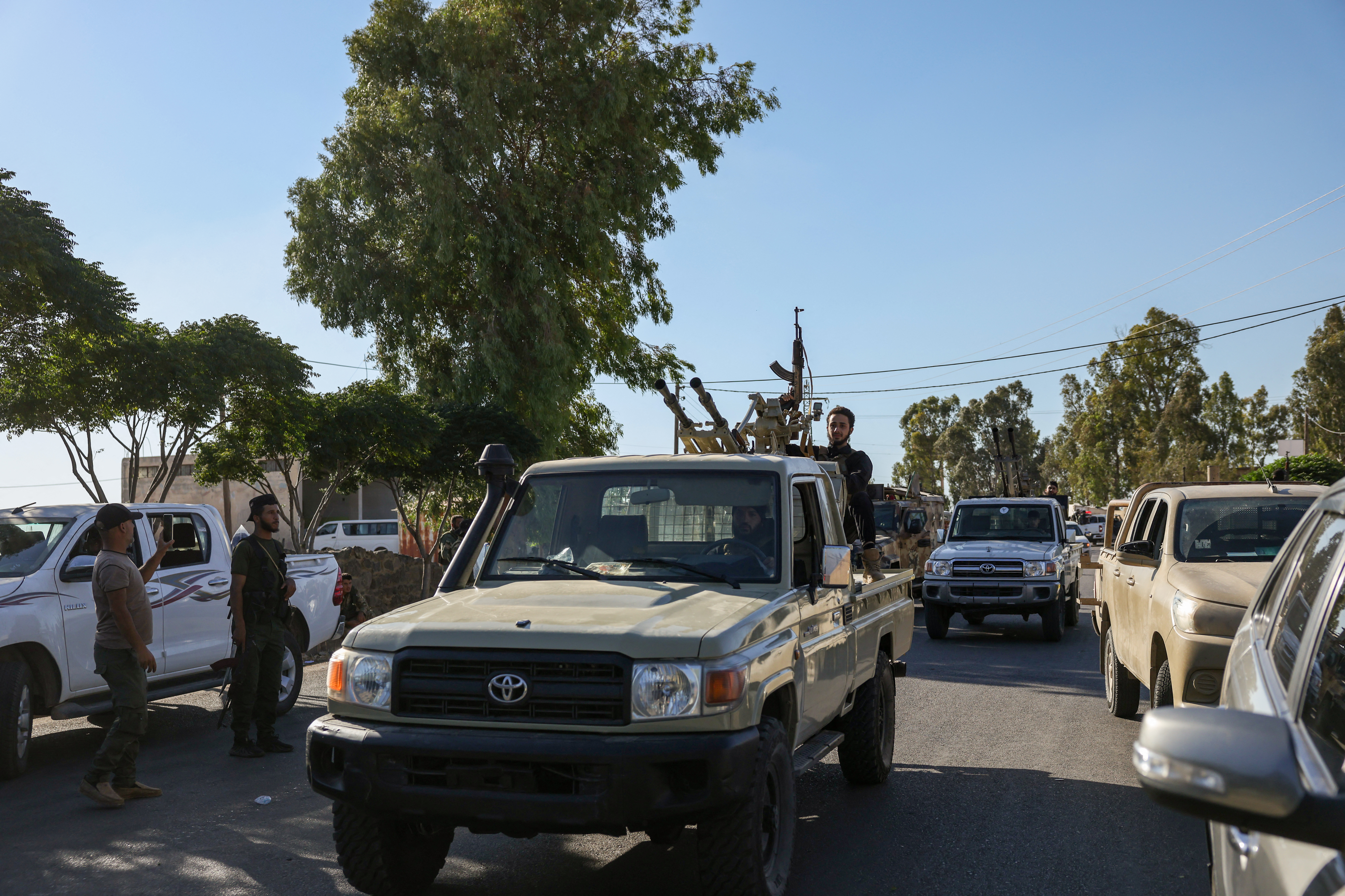 Members of Syria's security forces patrol an area.