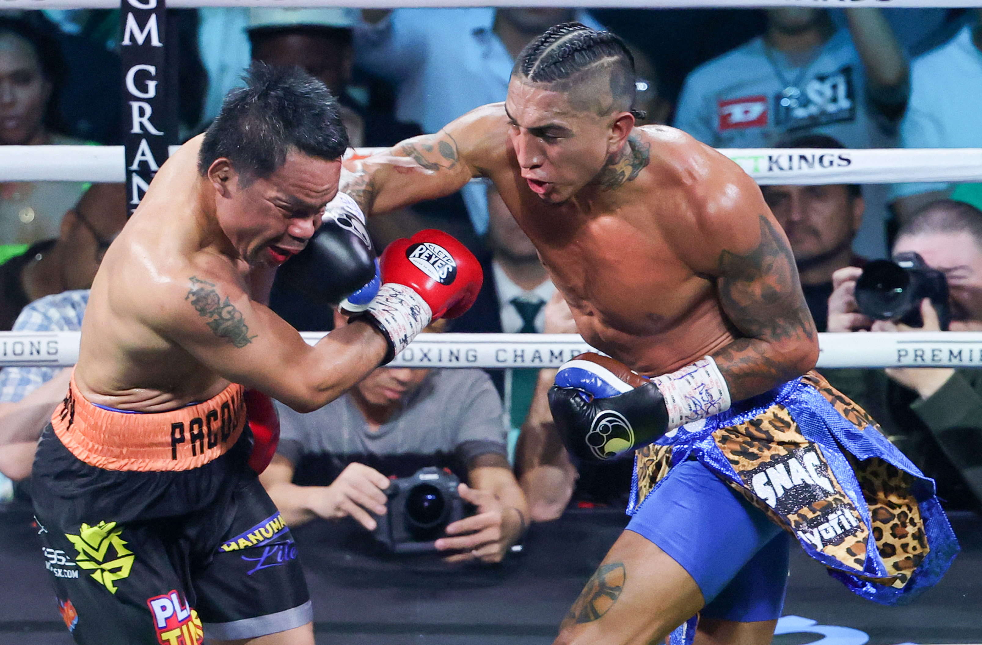 Mario Barrios (R) throws a right at Manny Pacquiao.