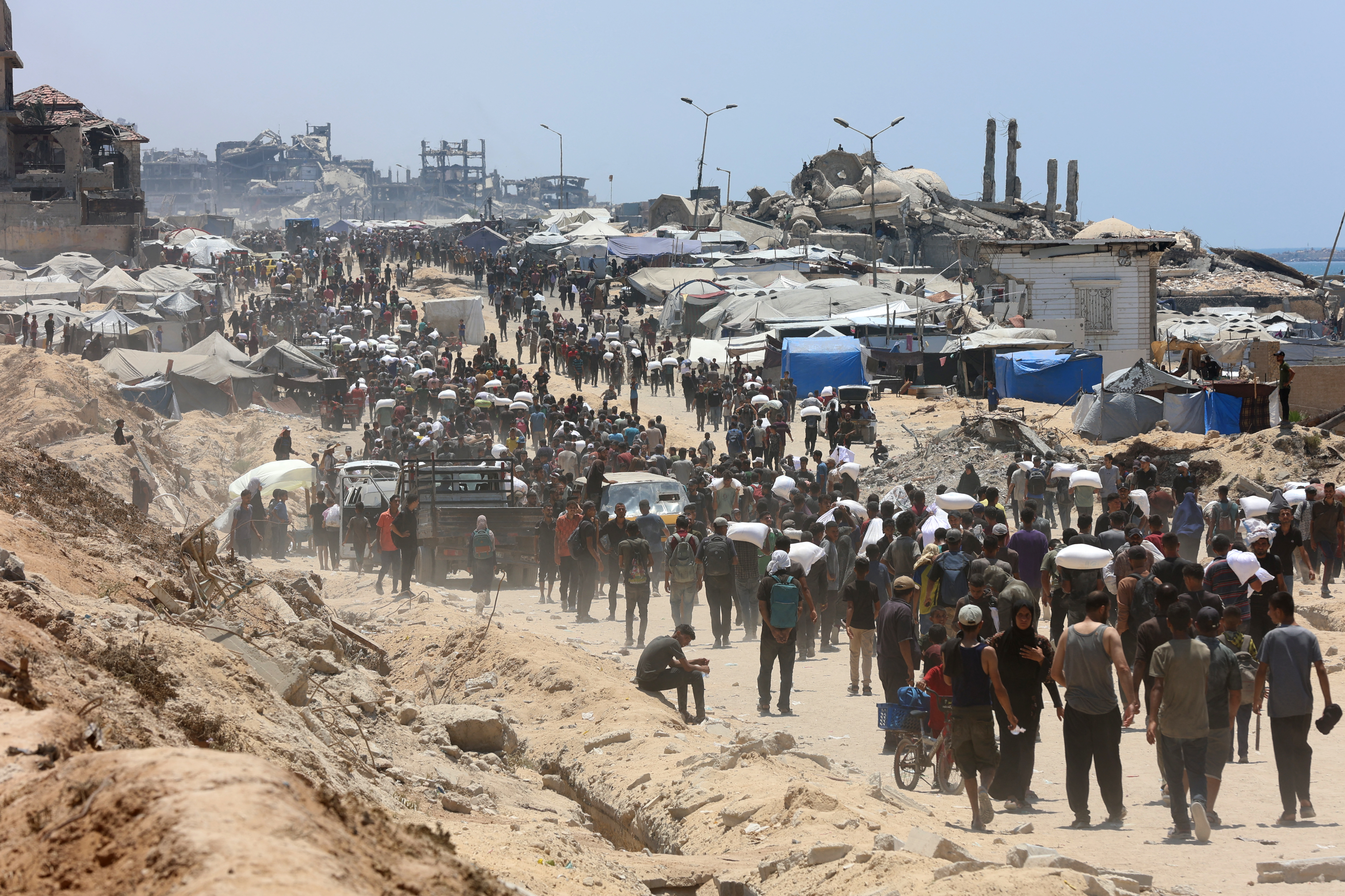 People make their way along al-Rashid street in western Jabalia