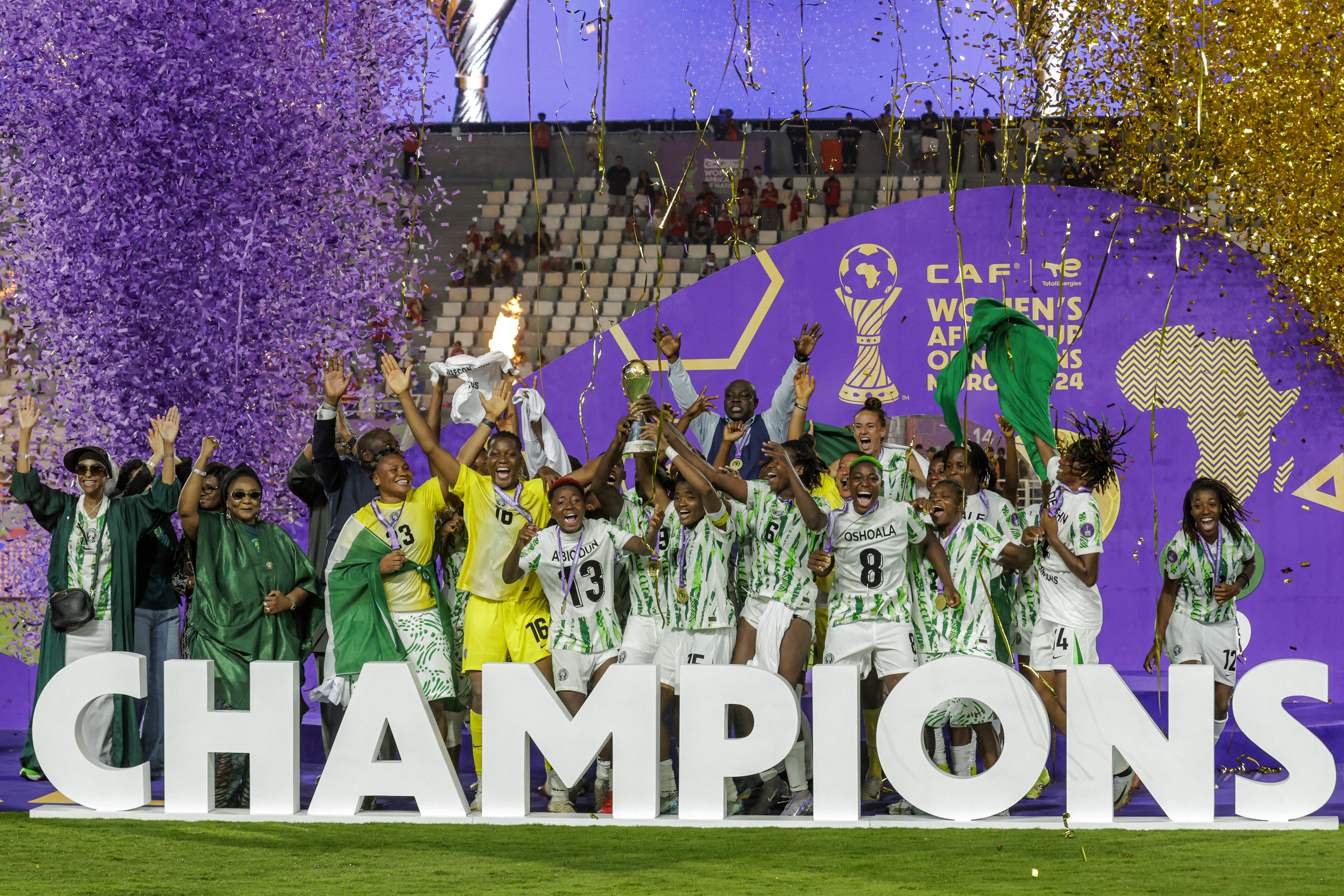 Nigeria's players celebrate with the trophy on the podium after winning the 2025 Women's Africa Cup of Nations final