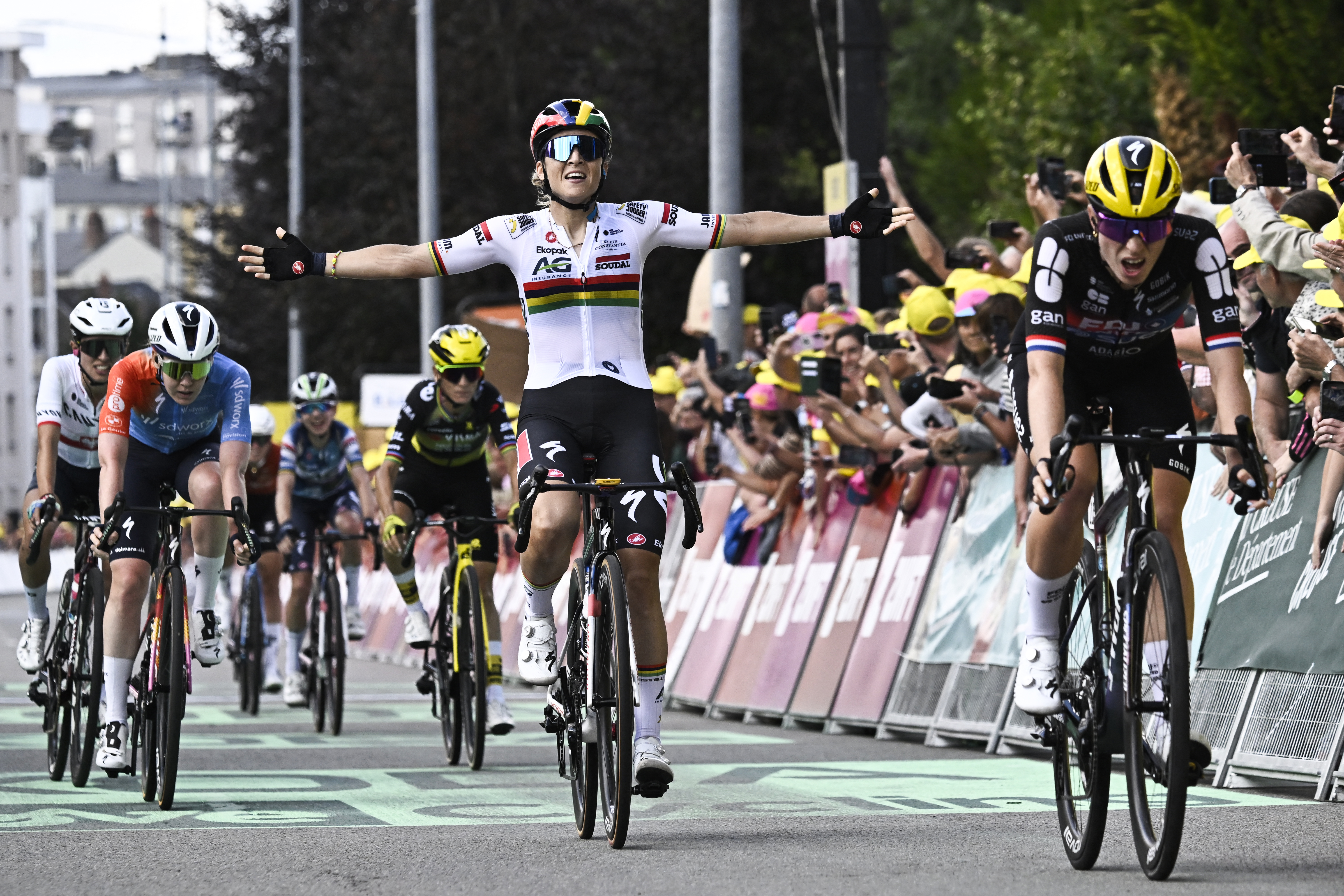 Soudal Team's Mauritius rider Kimberley Le Court Pienaar (C) celebrates next to FDJ-SUEZ team's Dutch rider Demi Vollering (R) as she cycles to the finish line to win the 5th stage (out of 9) of the fourth edition of the Women's Tour de France cycling race