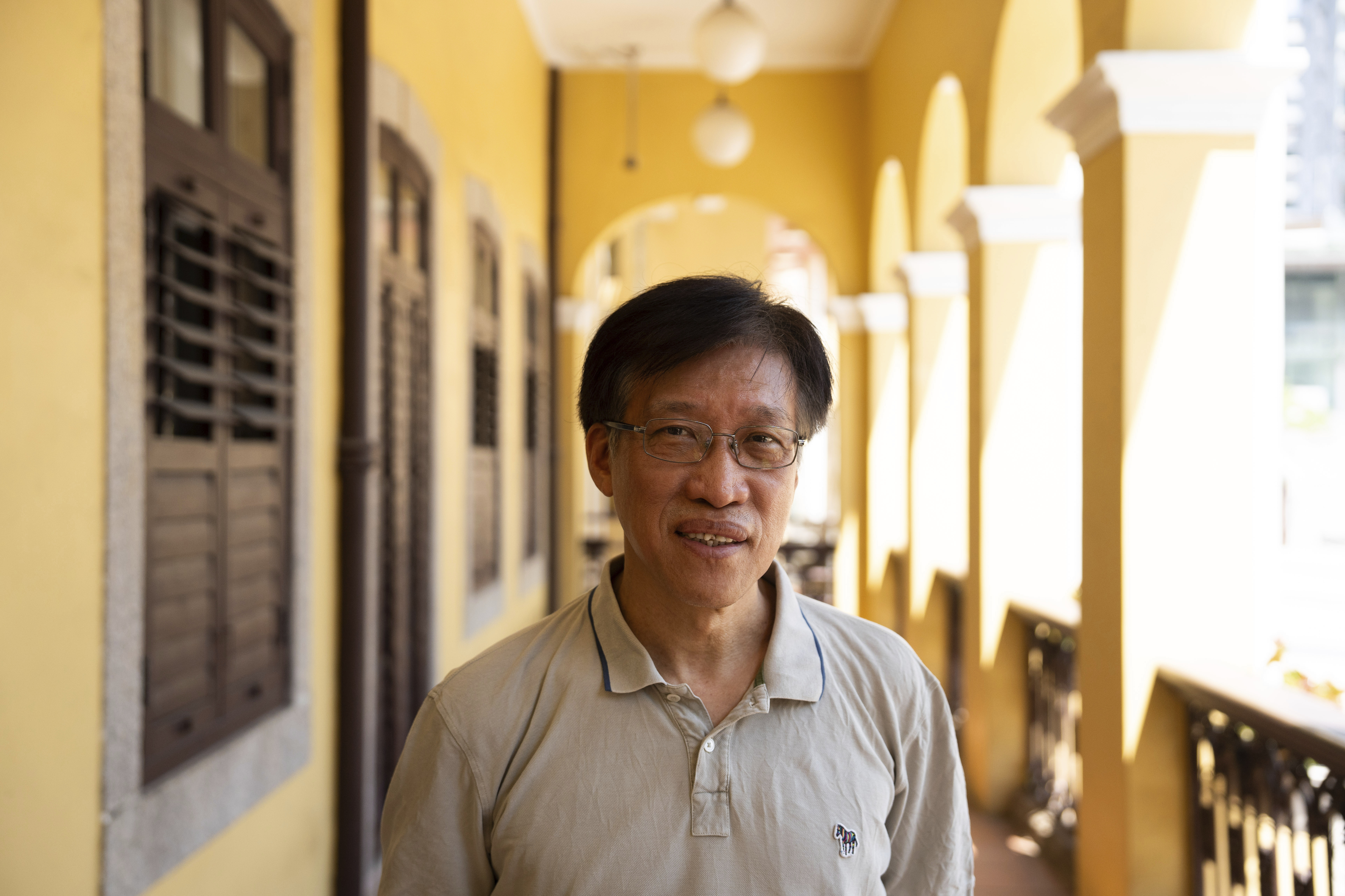 Veteran pro-democracy former lawmaker Au Kam San poses for a photo.