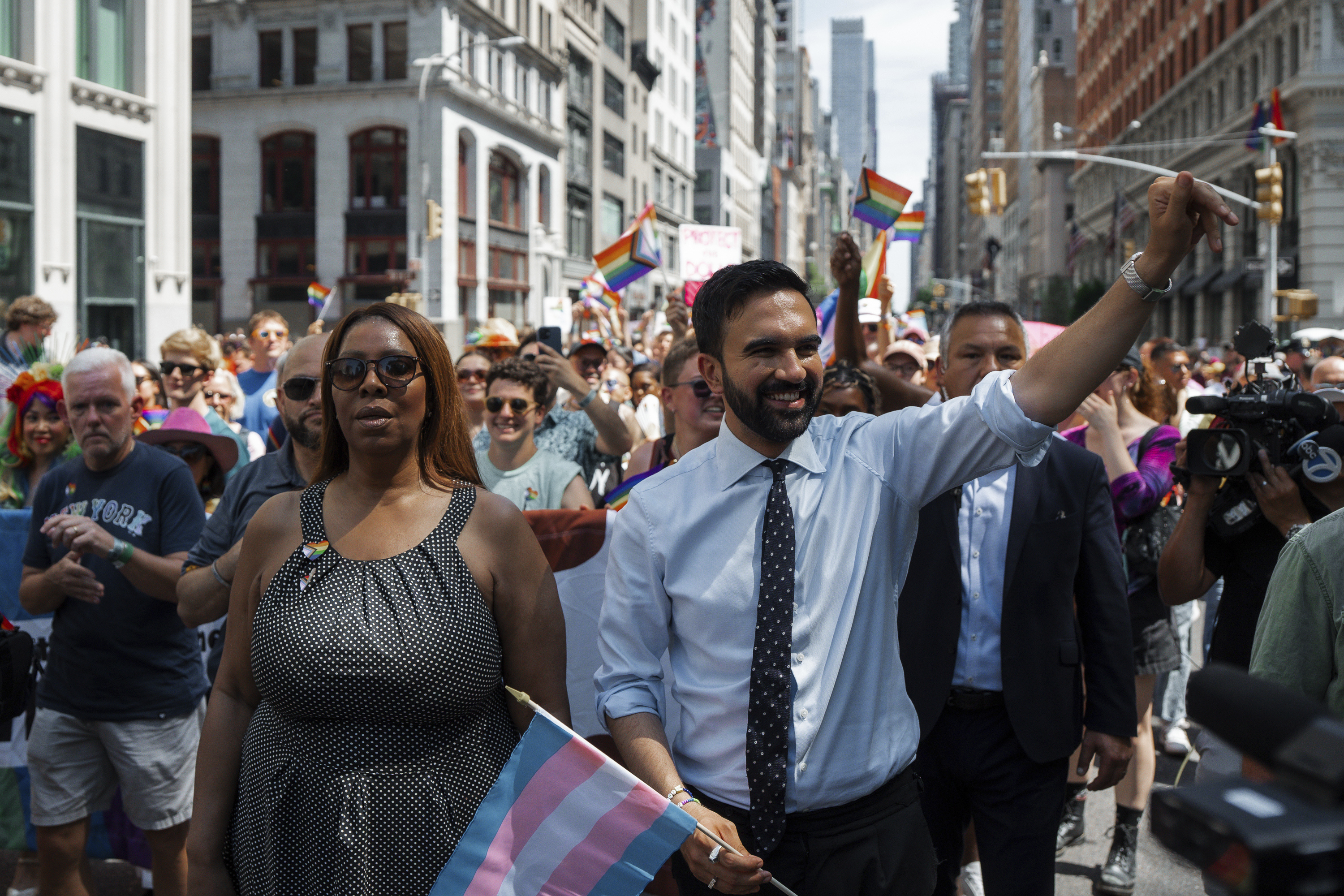 Zohran Mamdani walks at New York's Pride Parade with Letitia James and waves to the crowd.