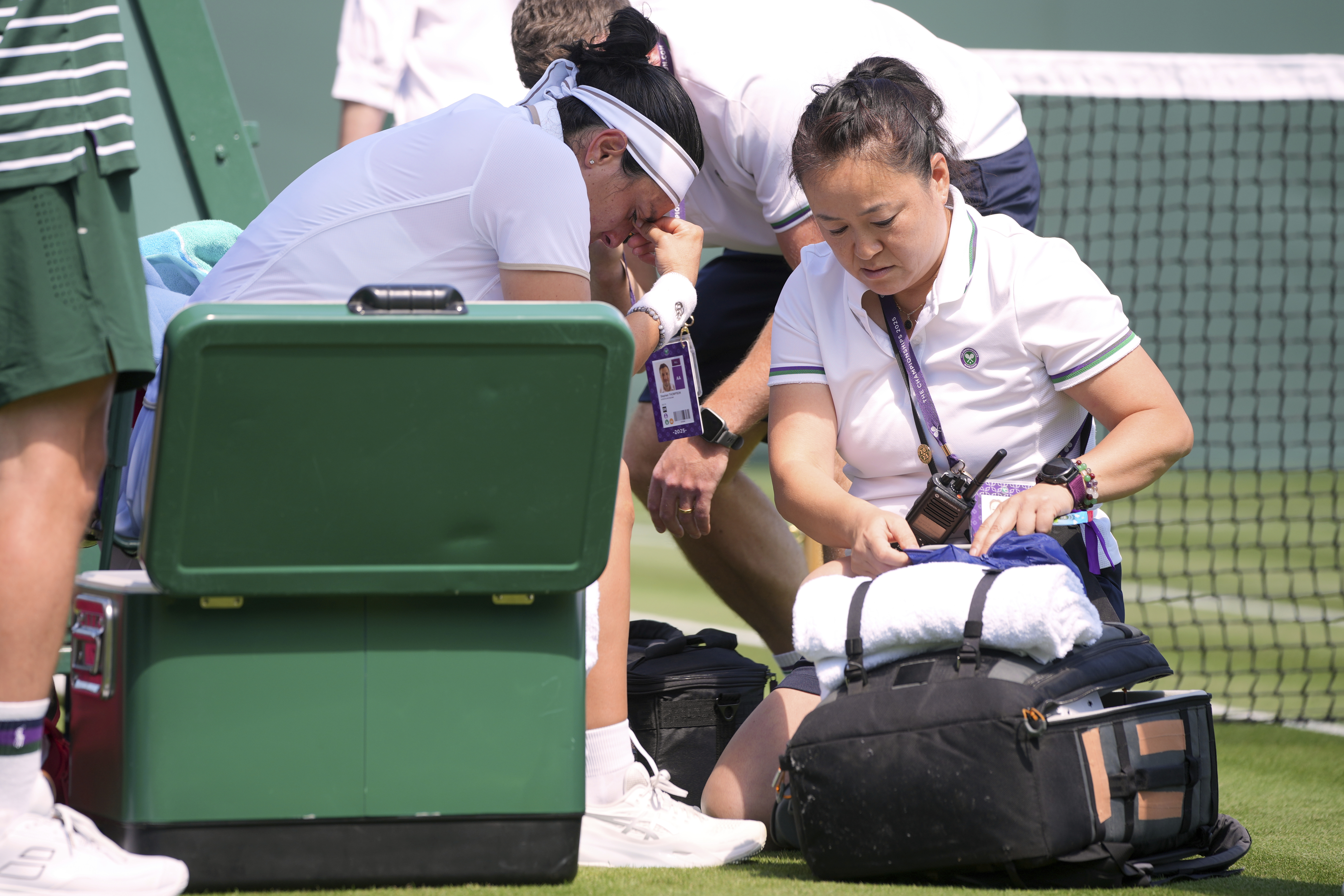 Ons Jabeur of Tunisia get medical assistance during her match against Varvara Gracheva of France at the first round singles match at the Wimbledon Tennis Championships