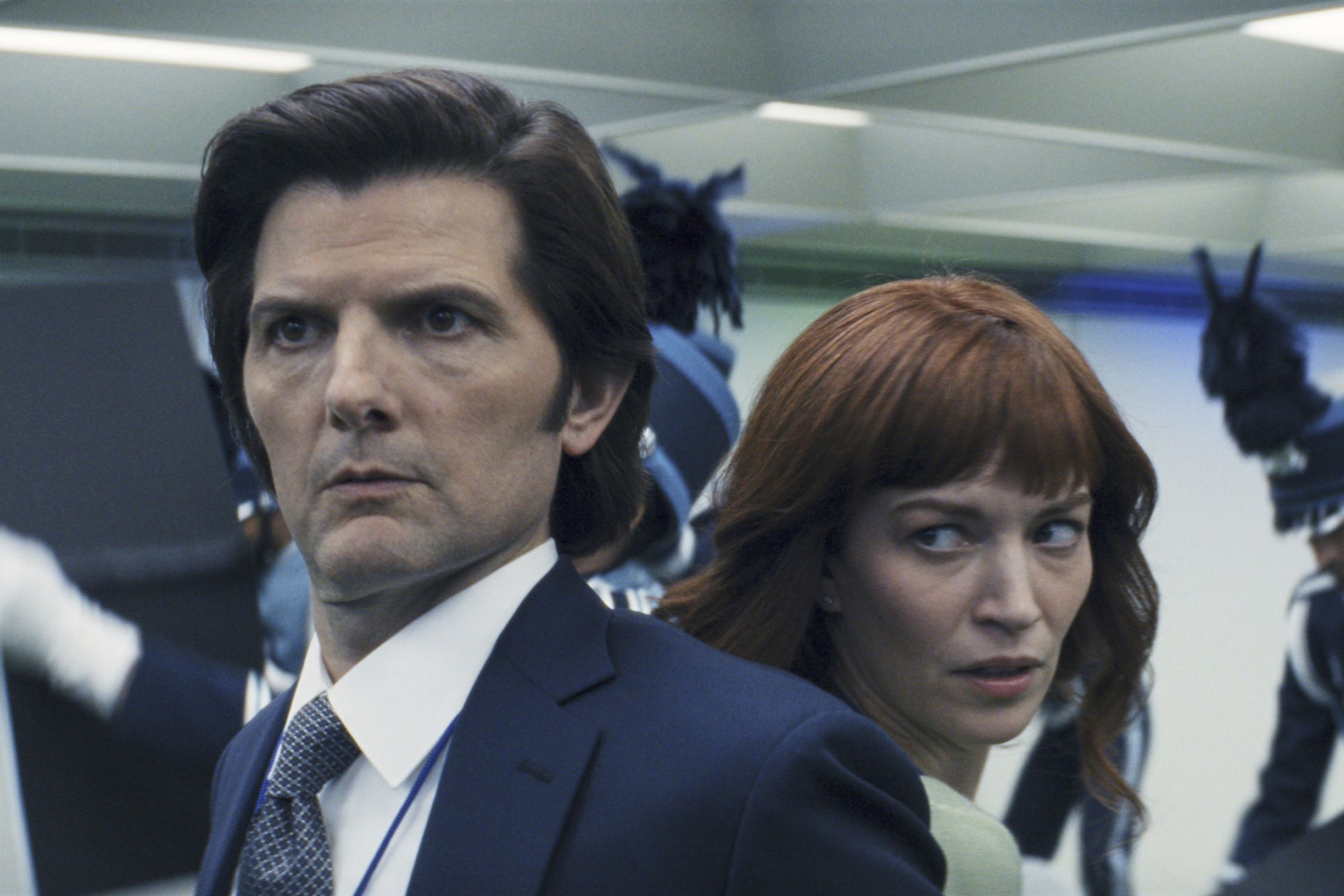 This image released by Apple TV+ shows Adam Scott, left, and Britt Lower in a scene from "Severance." (Apple TV+ via AP)