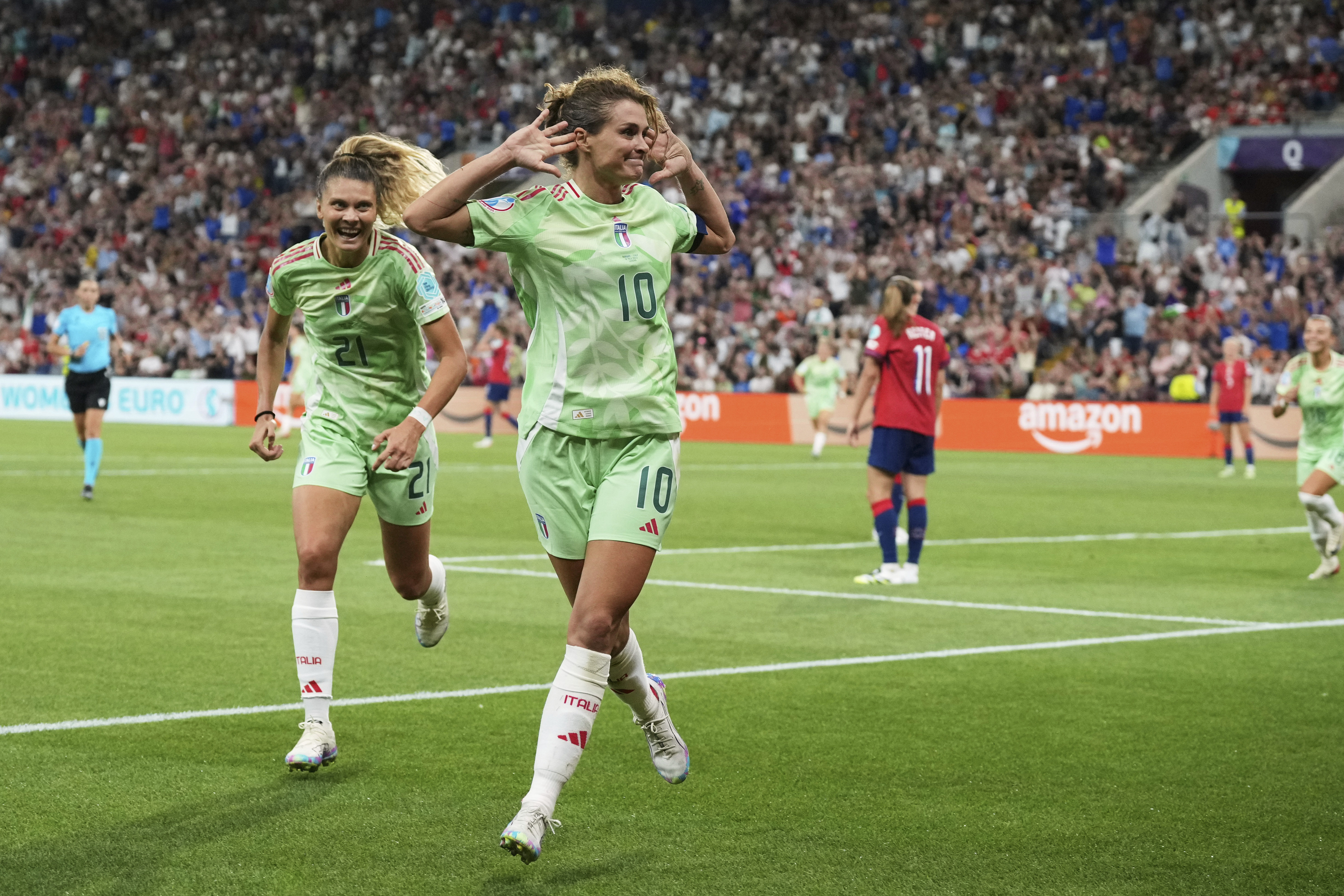 Italy's Cristiana Girelli cups her ears in celebration after scoring a 90th-minute winter against Norway to send her team to the Euro 2025 semifinals.