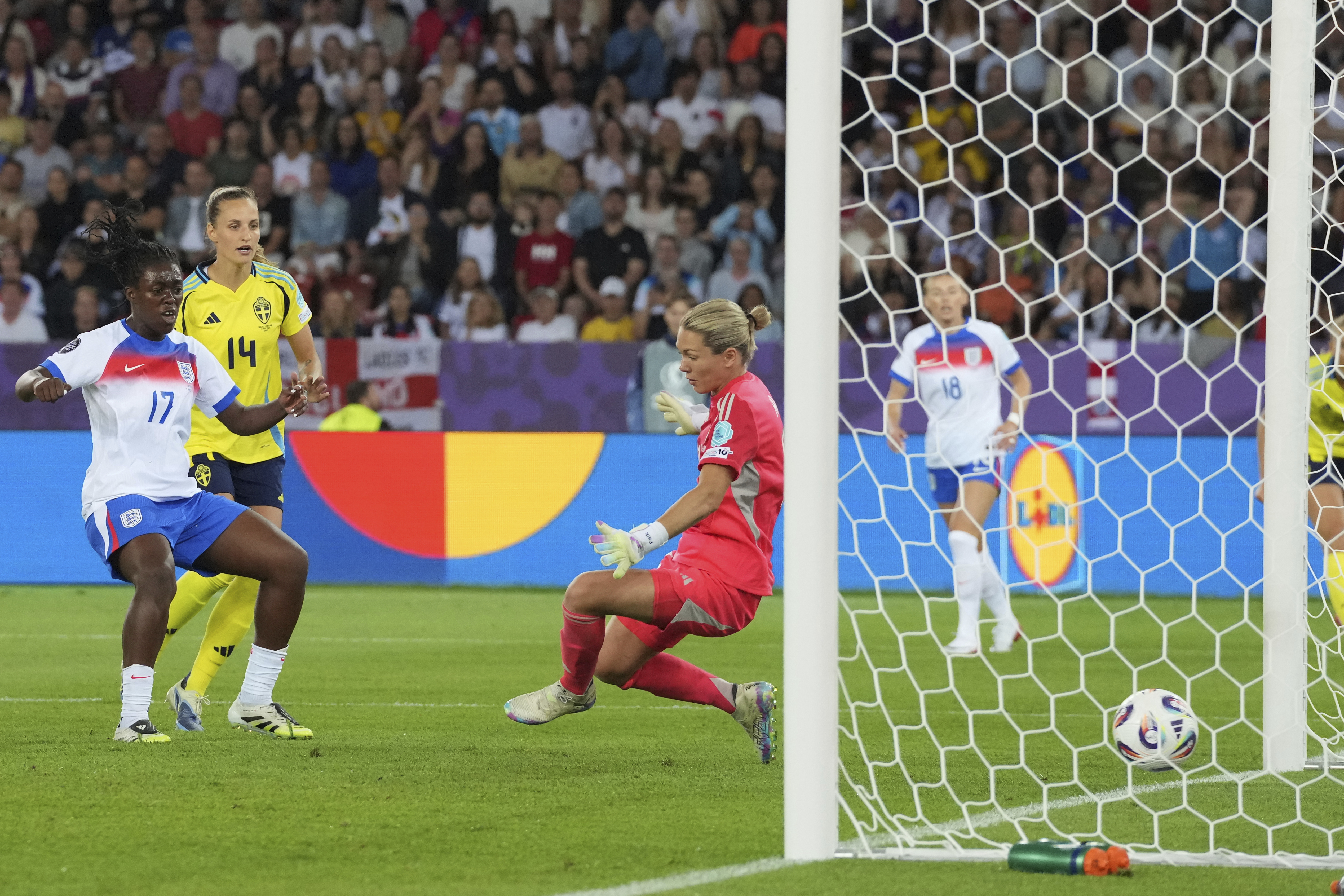 England's Michelle Agyemang, left, shoots to score her sides second goal past Sweden goalkeeper Jennifer Falk during the Women's Euro 2025 quarterfinals soccer match between Sweden and England at Stadion Letzigrund in Zurich, Switzerland, Thursday, July 17, 2025. (AP Photo/Martin Meissner)