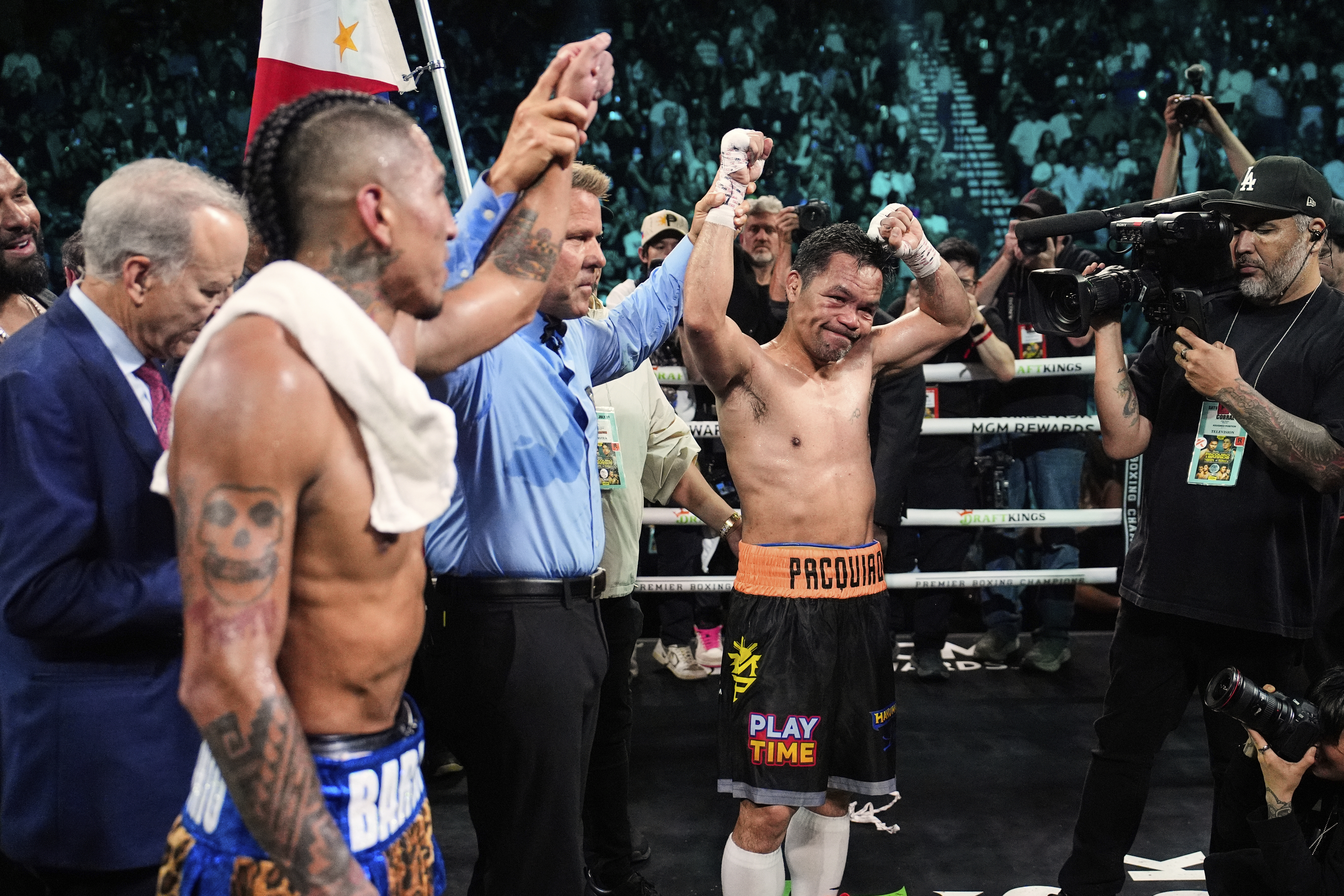 Mario Barrios, left, and Manny Pacquiao reacts.