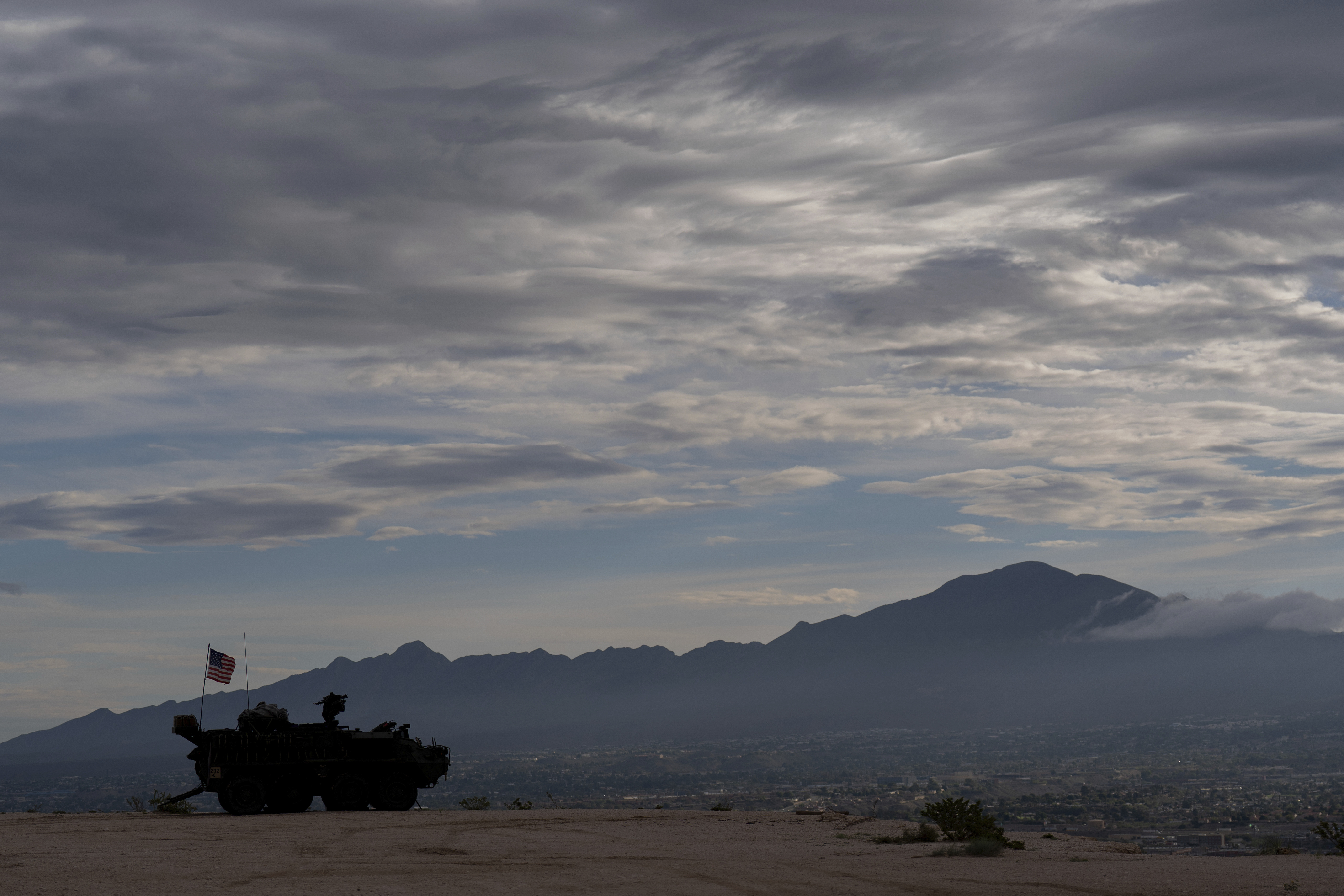 A Stryker combat vehicle sits atop a hill overlooking the U.S.-Mexico border fence in Sunland Park, N.M., Wednesday, July 23, 2025. (AP Photo/Jae C. Hong)