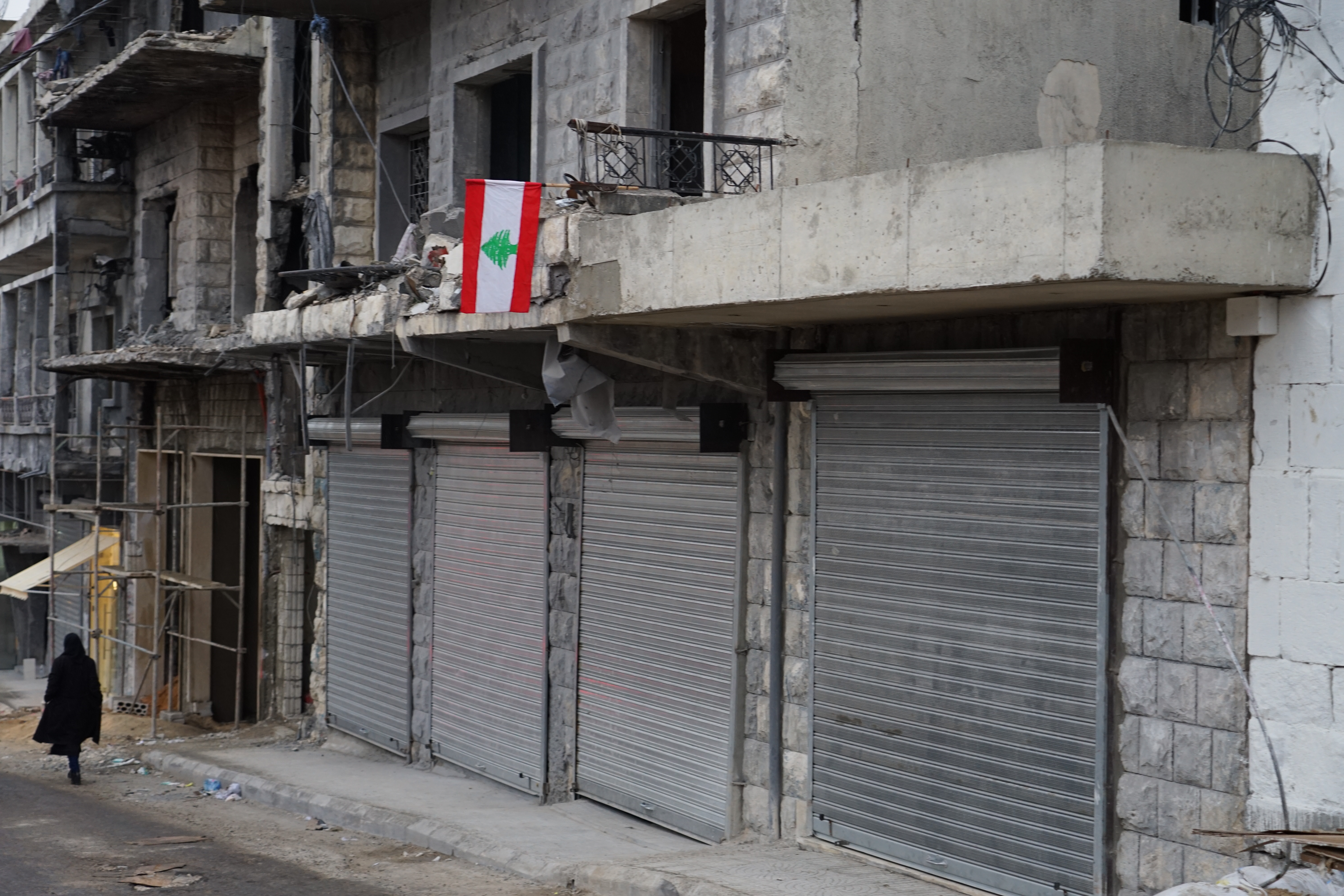 A Lebanese flag hangs over a shuttered store