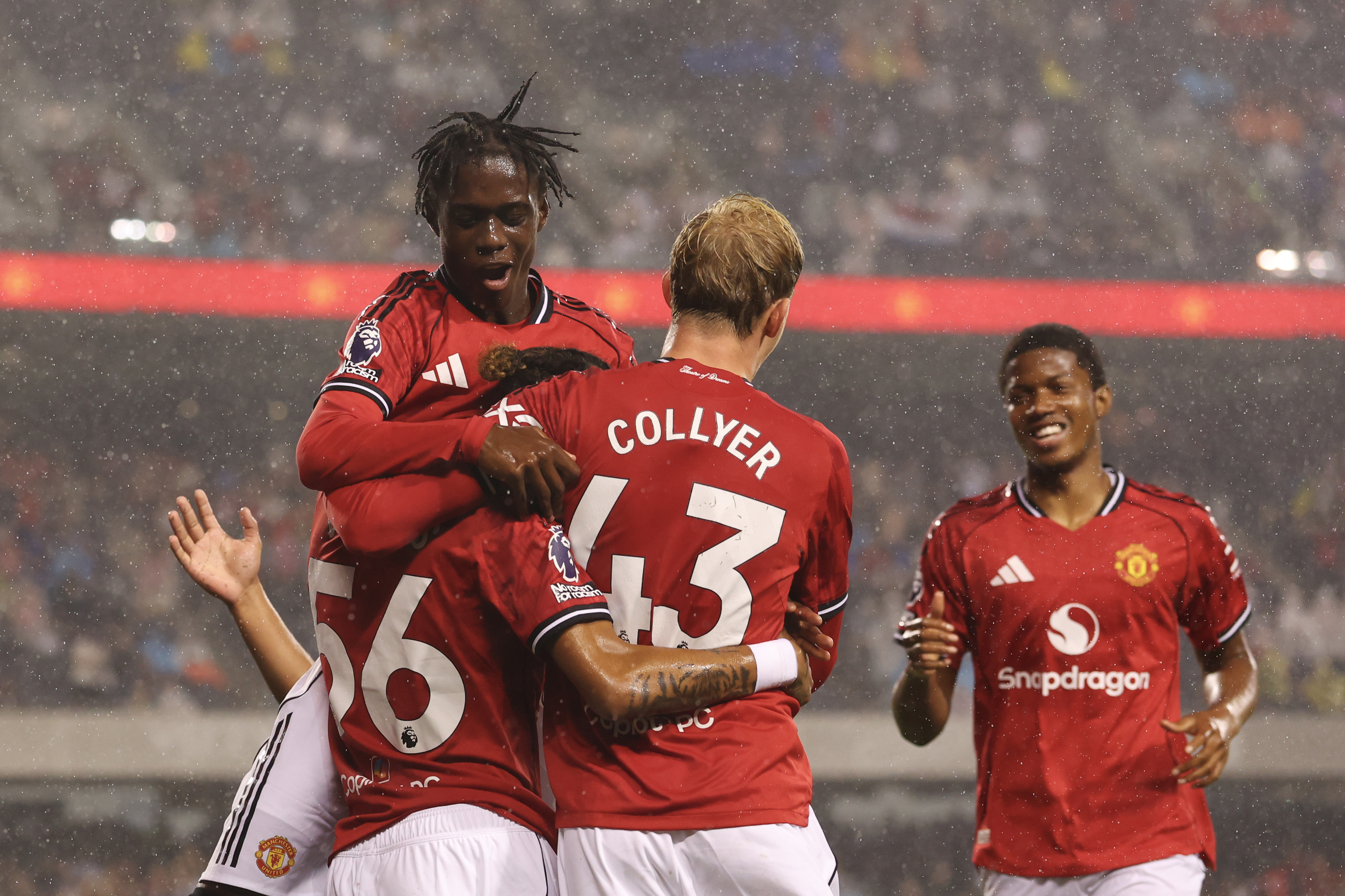 Ethan Williams of Manchester United celebrates with teammates.