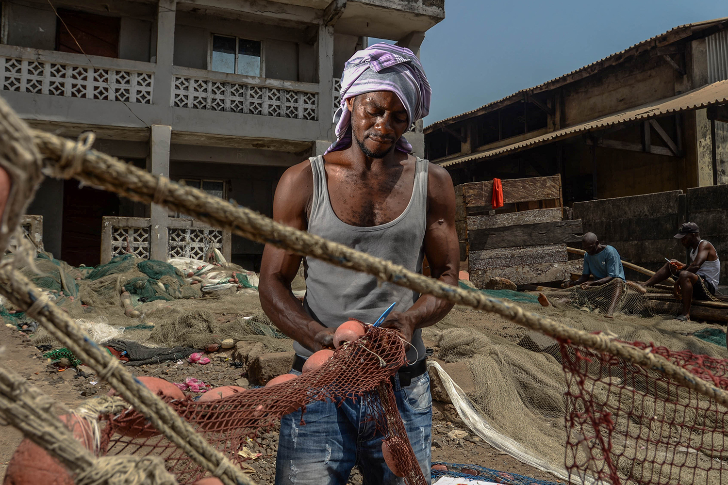 A diver fixes his nets [Olivia Acland/Al Jazeera]