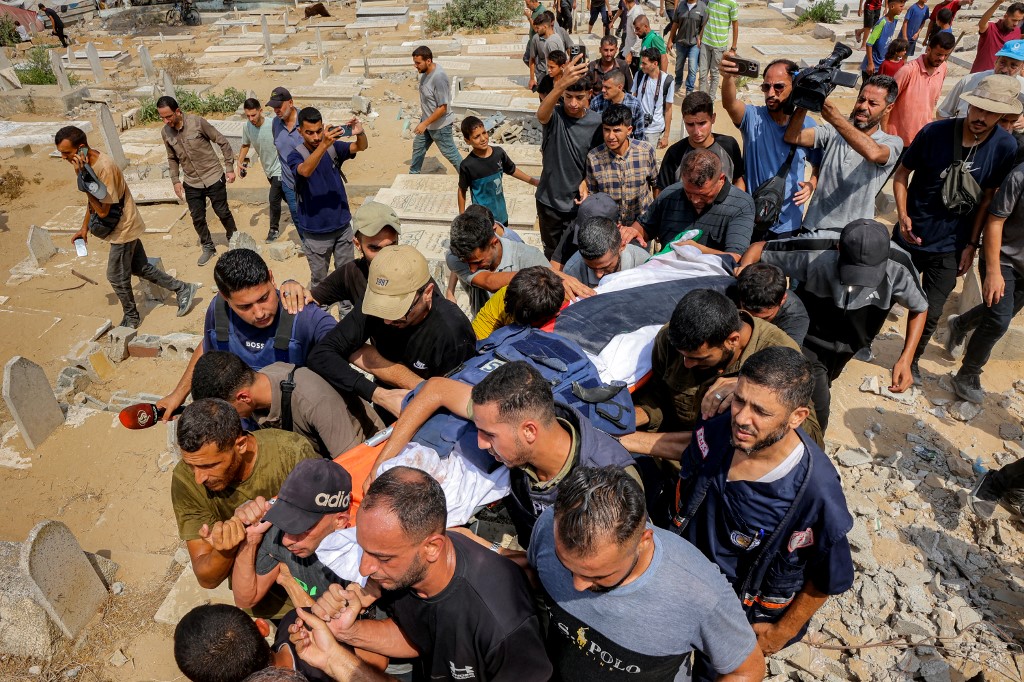 Mourners carry one of the bodies of the Al Jazeera staff.