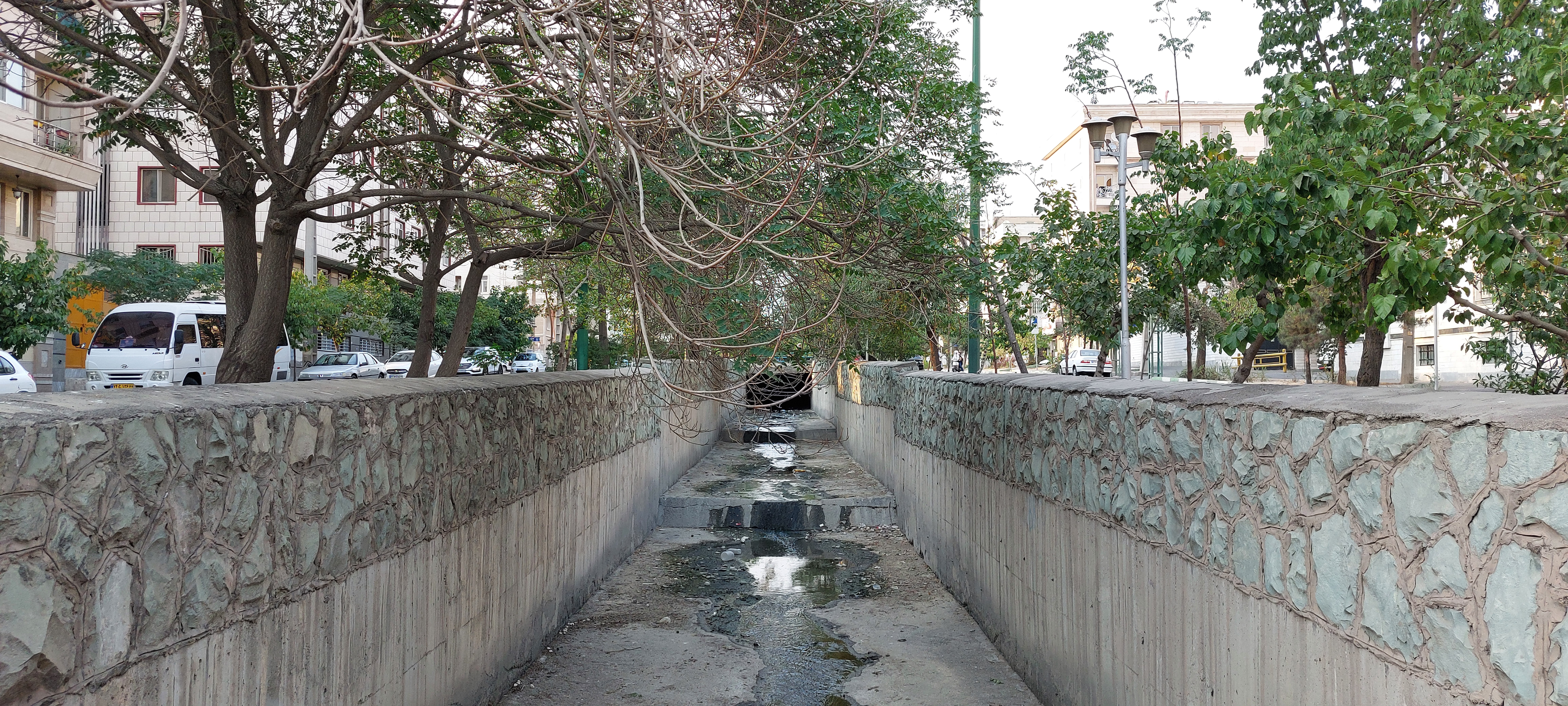 A photo of a water channel that has dried to the point where all that's left is a puddle