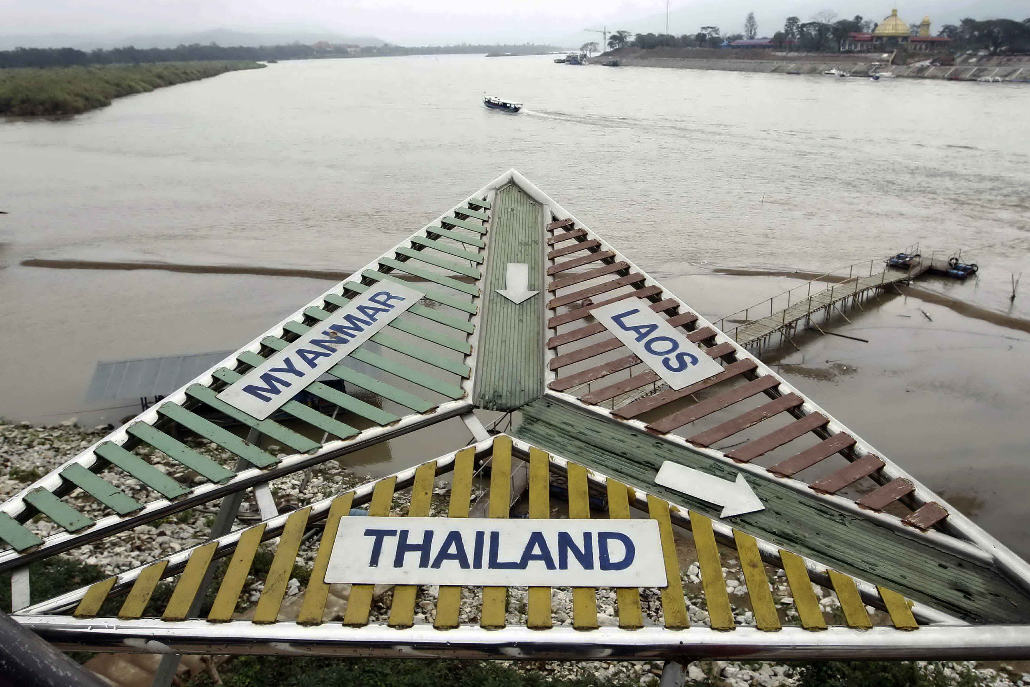 A signboard at the Thai village of Sop Ruak on the Mekong river in the Golden Triangle region where the borders of Thailand, Laos and Myanmar meet January 14, 2012. The murder of 13 Chinese sailors last October on the Mekong was the deadliest attack on Chinese nationals overseas in modern times and highlights the growing presence of China in the Golden Triangle, the opium-growing region straddling Myanmar, Laos and Thailand. Picture taken January 14, 2012. To match Special Report MEKONG-CHINA/MURDERS REUTERS/Sukree Sukplang (THAILAND - Tags: CIVIL UNREST MARITIME POLITICS BUSINESS)