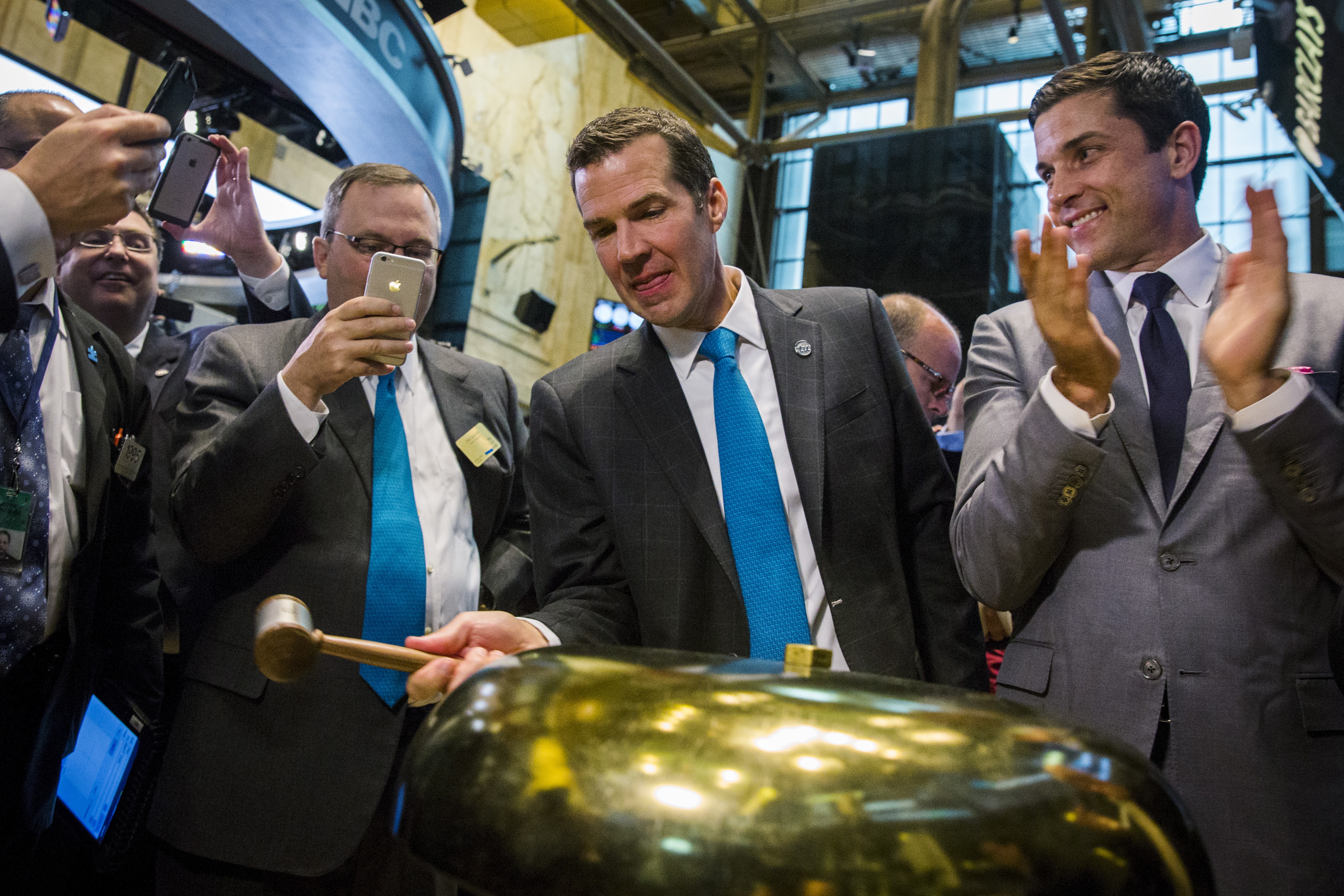 TransUnion Corp. President and CEO Jim Peck rings a ceremonial bell on the floor of the New York Stock Exchange.
