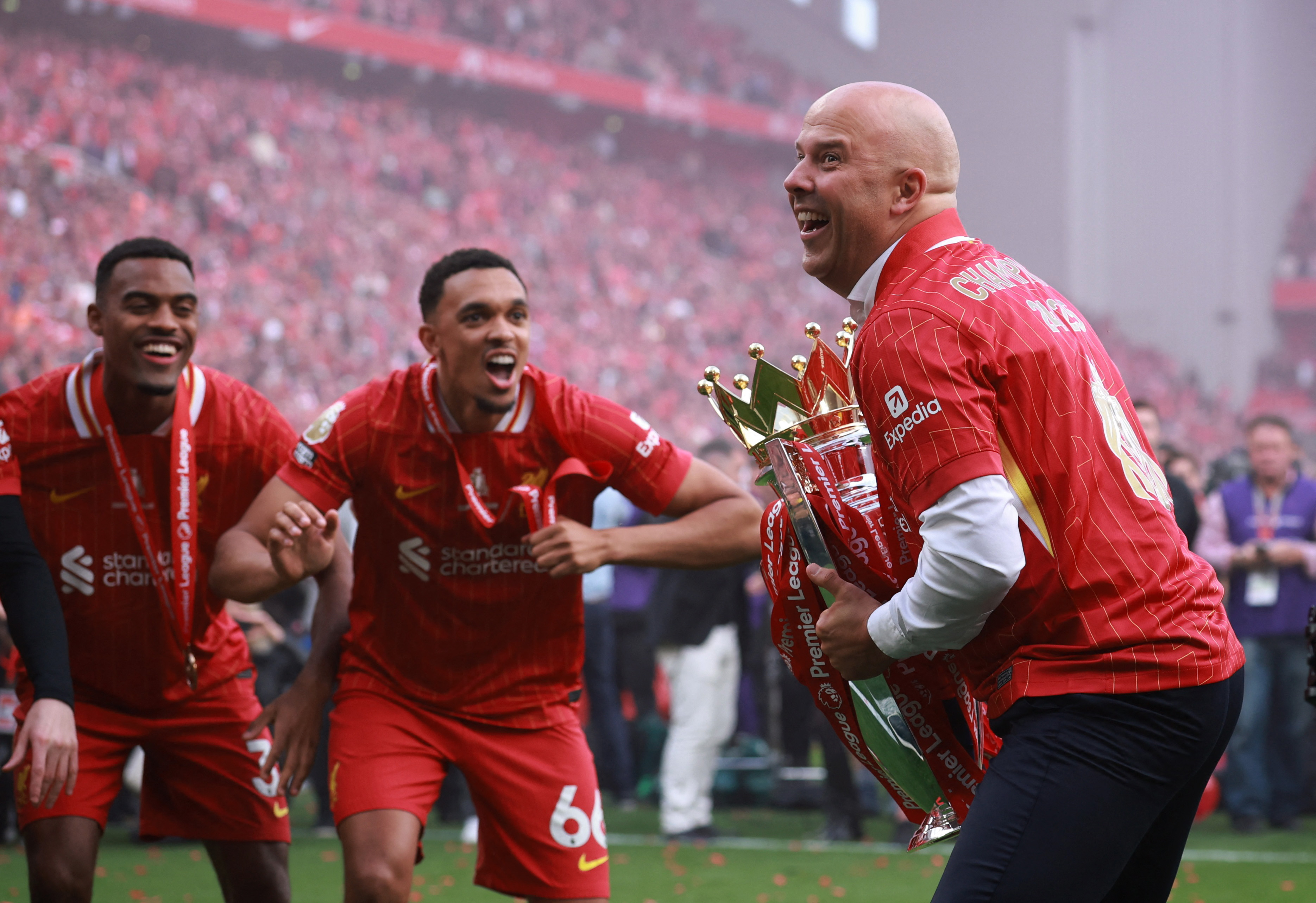 Liverpool manager Arne Slot celebrates with the trophy after winning the Premier League 