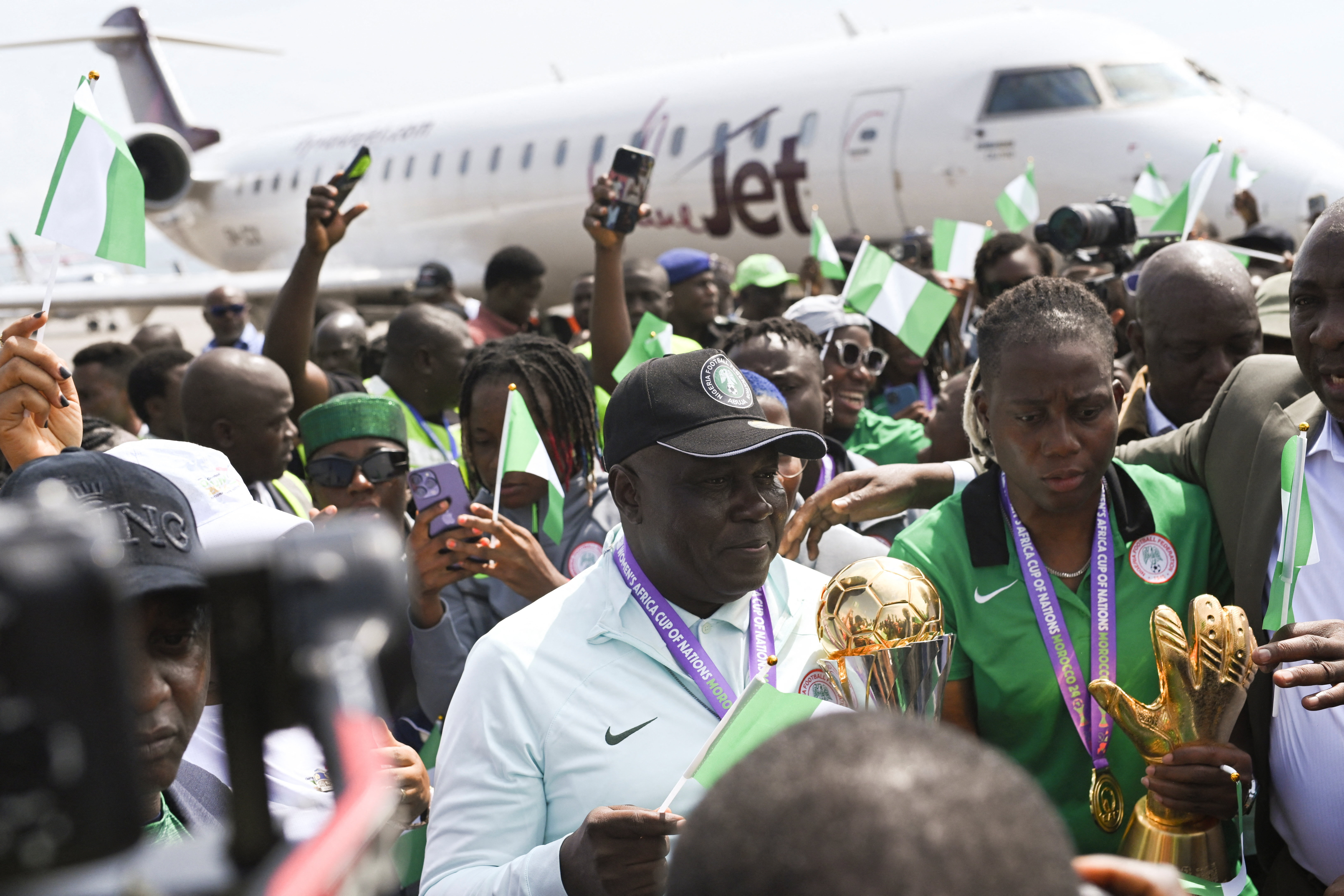 Nigeria’s Super Falcons head coach Justin Madugu and goalkeeper Chiamaka Nnadozie arrive at Nnamdi Azikiwe International Airport in Abuja, following the team’s victory in Women’s Africa Cup of Nation in Morocco in July