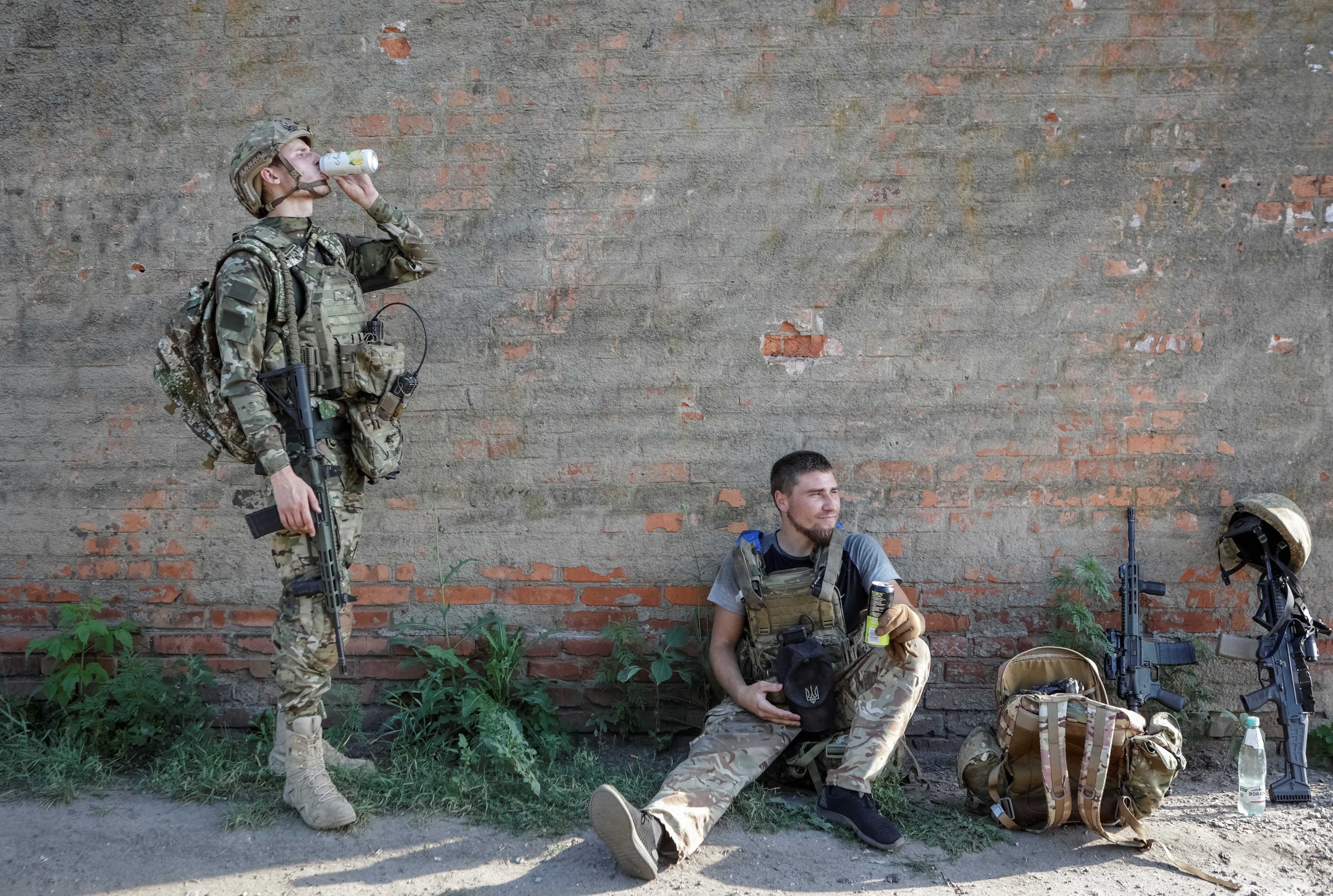 Service members of the 13th Operative Purpose Brigade 'Khartiia' of the National Guard of Ukraine rest as they return from a combat mission, amid Russia's attack on Ukraine, in Kharkiv region, Ukraine, August 2, 2025. REUTERS/Sofiia Gatilova