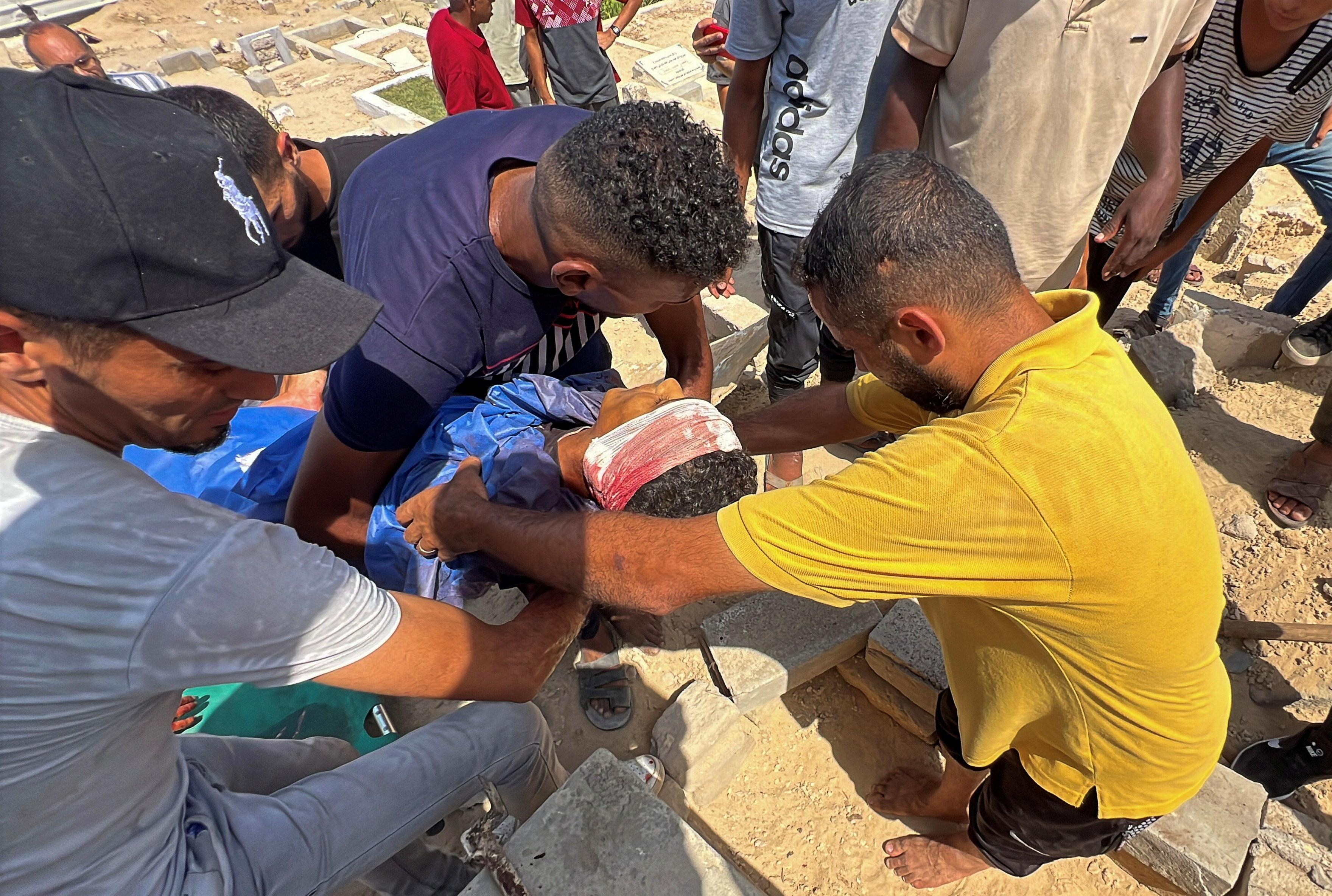 Mourners carry the body of Palestinian boy Muhannad Eid, who died after being struck by a box of airdropped aid, during the funeral, in Nuseirat, in the central Gaza Strip, August 9, 2025.